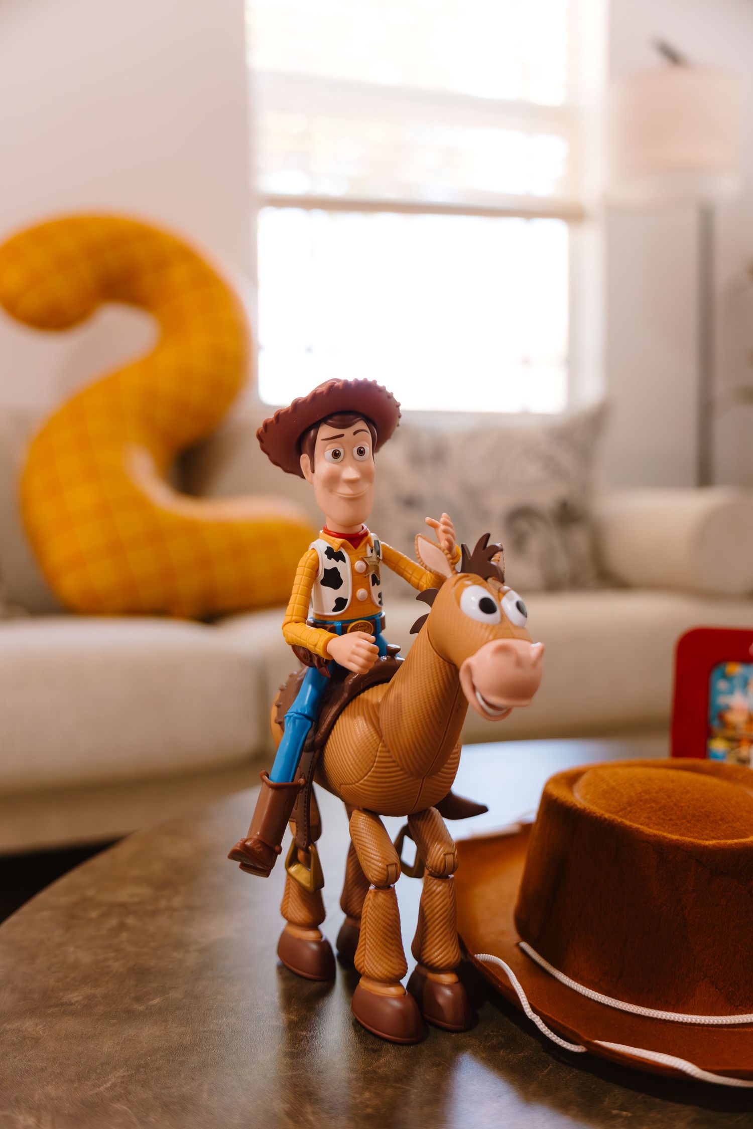 Woody and Bullseye Toy Story figurines displayed on a table at a Toy Story themed birthday party.