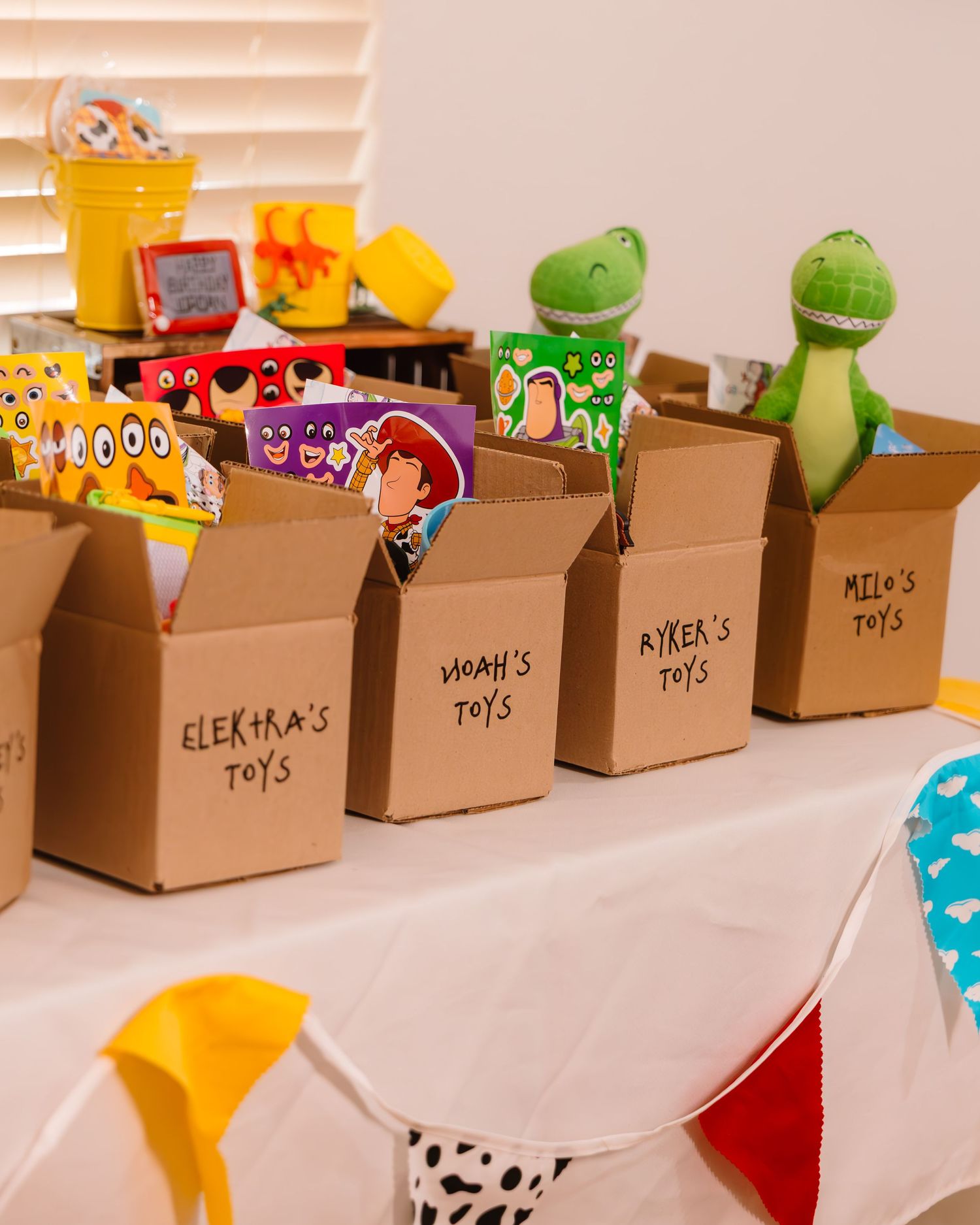 Toy Story themed birthday party room with letter blocks spelling JORDA and cowboy hats on tables.