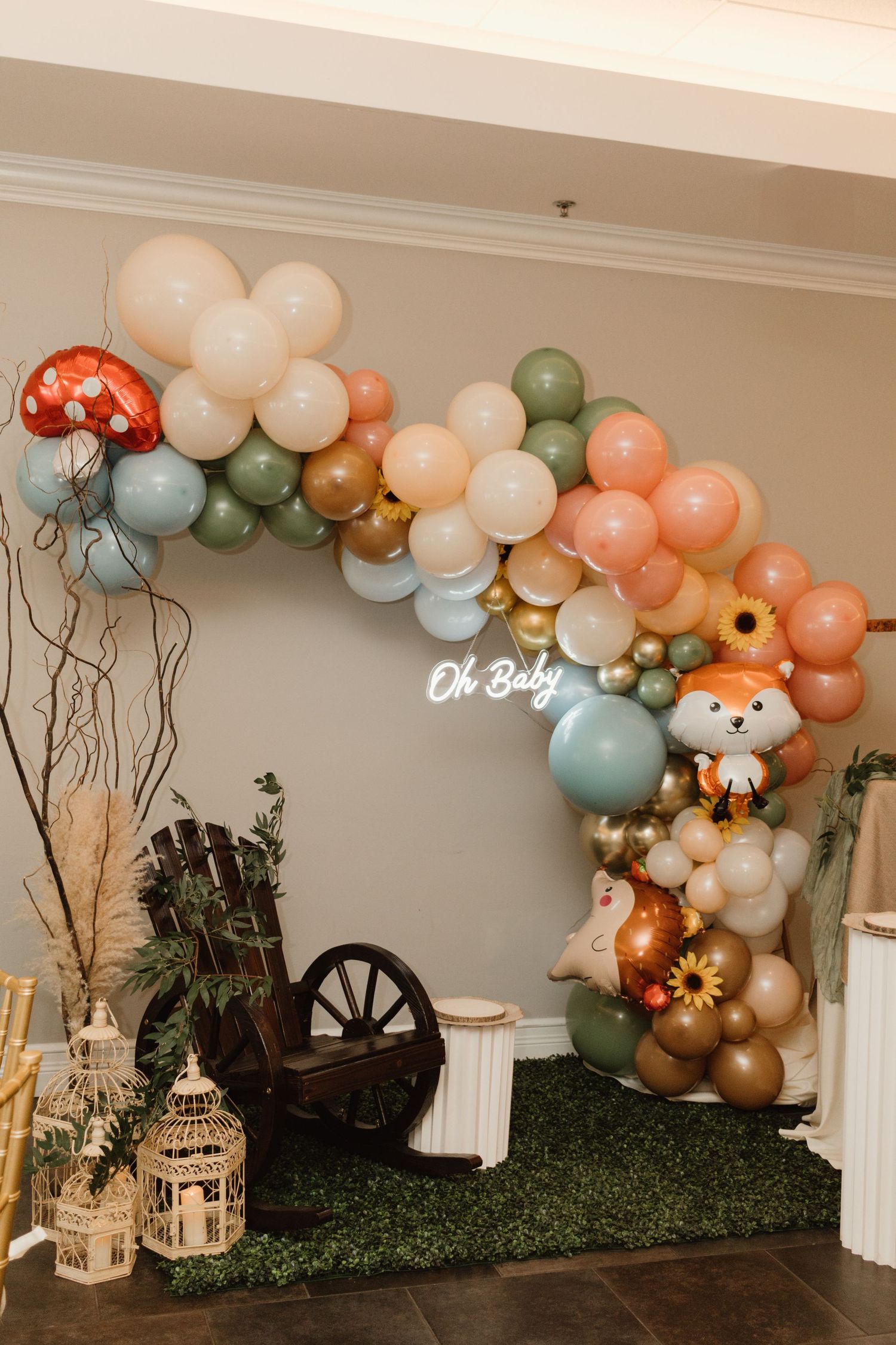 Woodland themed baby shower balloon garland arch with fox and mushroom foil balloons.