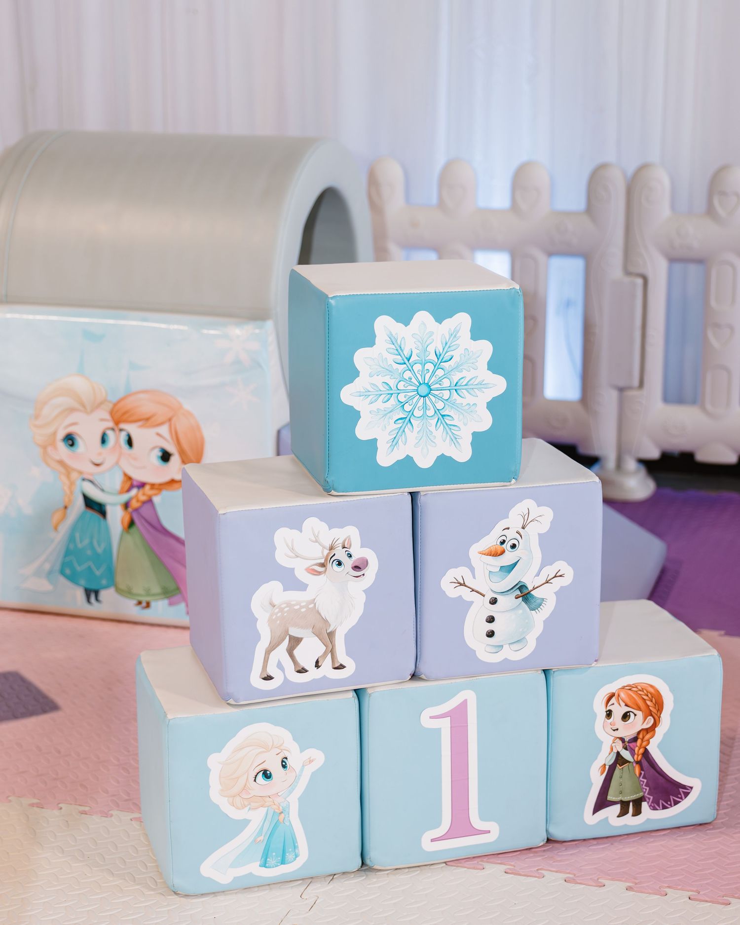 Frozen-themed birthday blocks stacked with Elsa, Anna, Olaf, and Sven characters showing number 1.