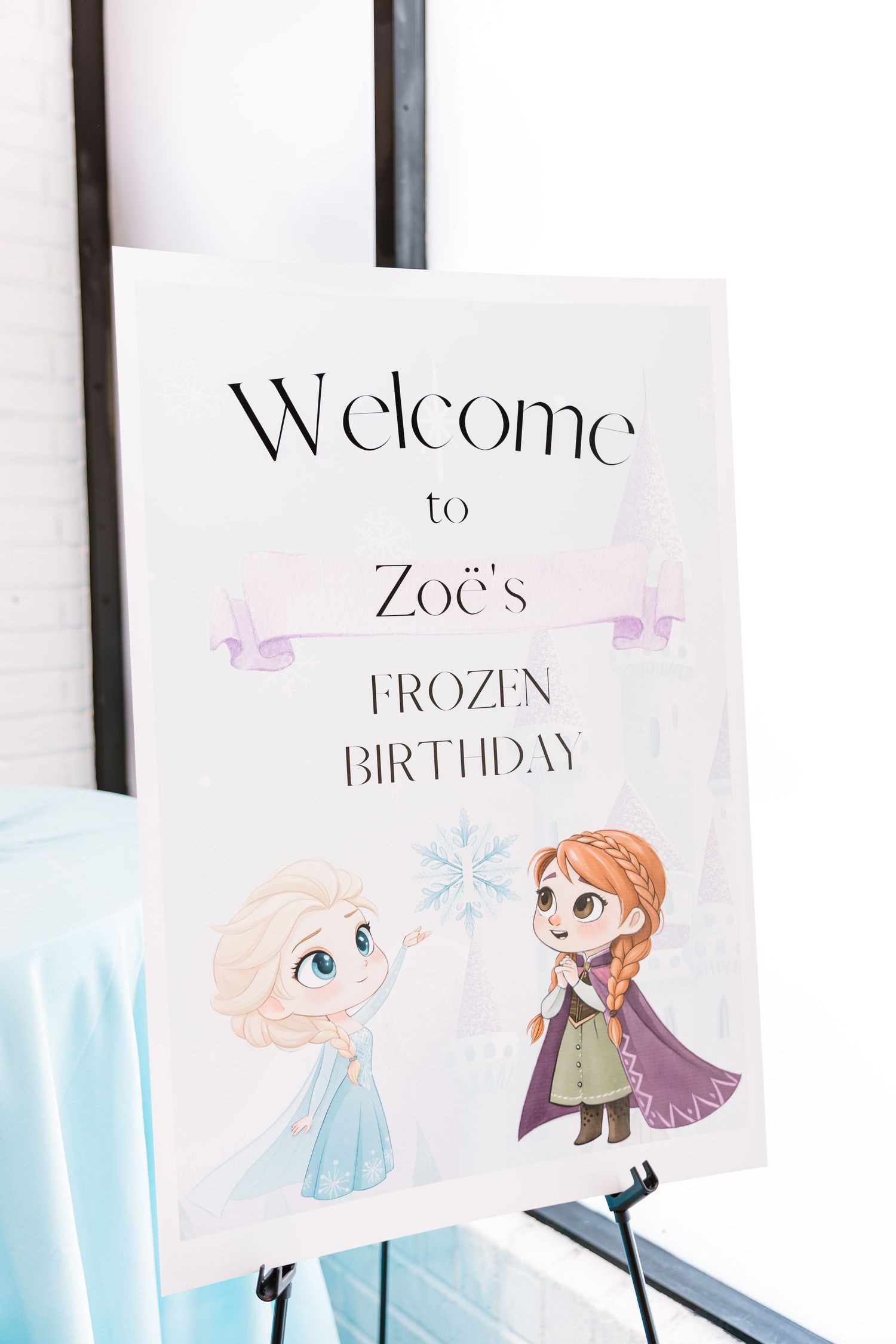 Welcome sign for Zoe's Frozen Birthday party featuring chibi Elsa and Anna illustrations.