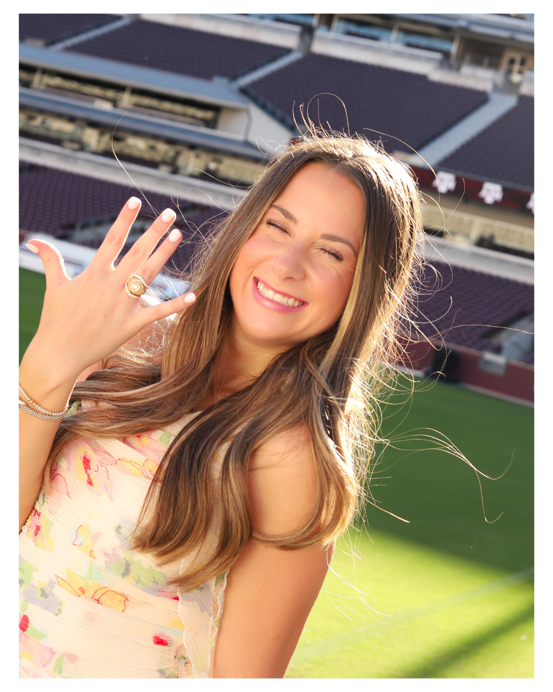 Candid moments in floral dress at football stadium with stadium seating visible.