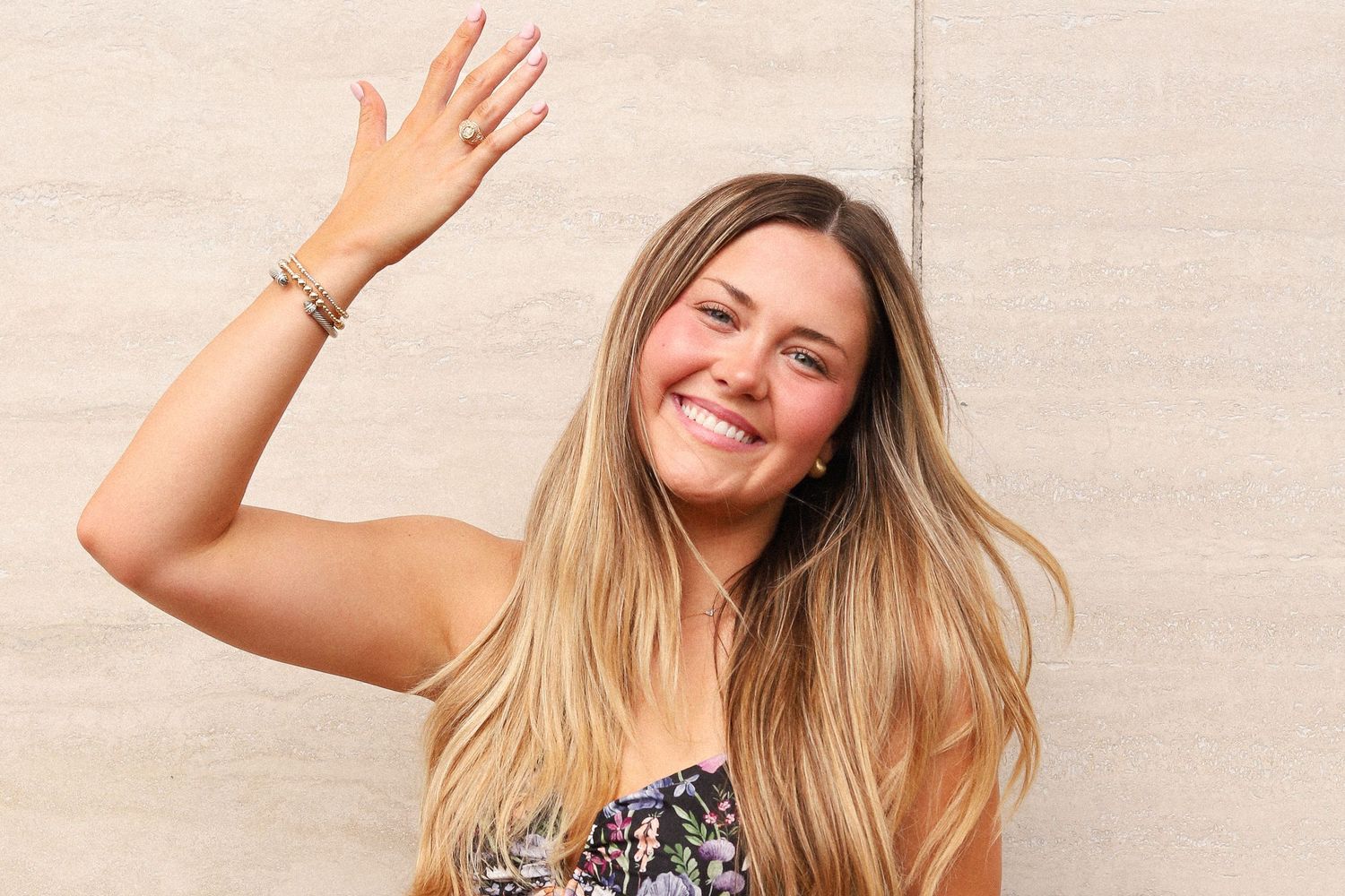 Cheerful poses against neutral wall background with natural lighting.