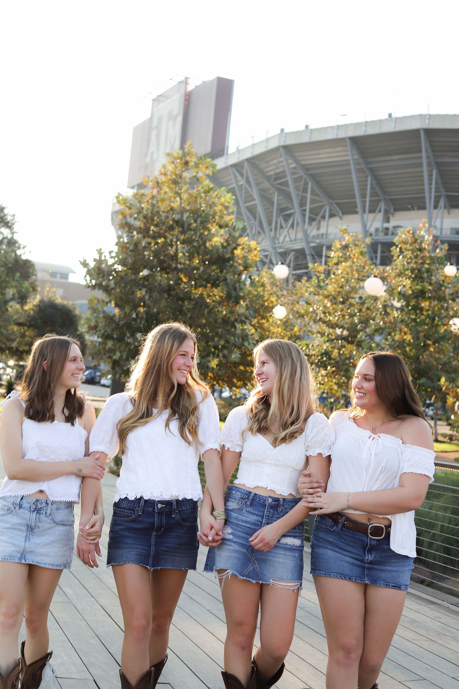 Candid moments of friends laughing together on a boardwalk in coordinated casual outfits.