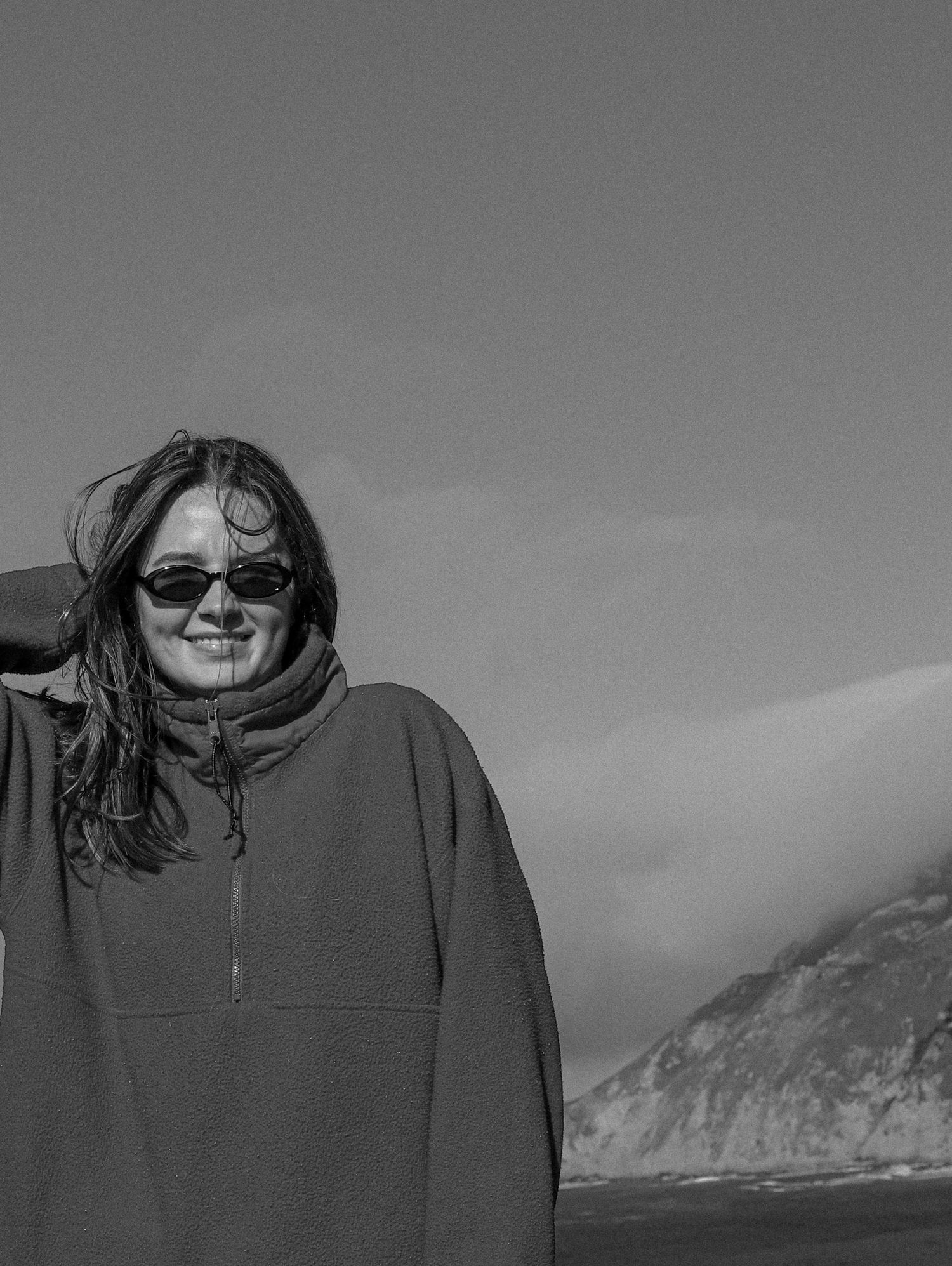 A black and white photo sequence shows someone in sunglasses and a hoodie smiling while outdoors in winter weather.