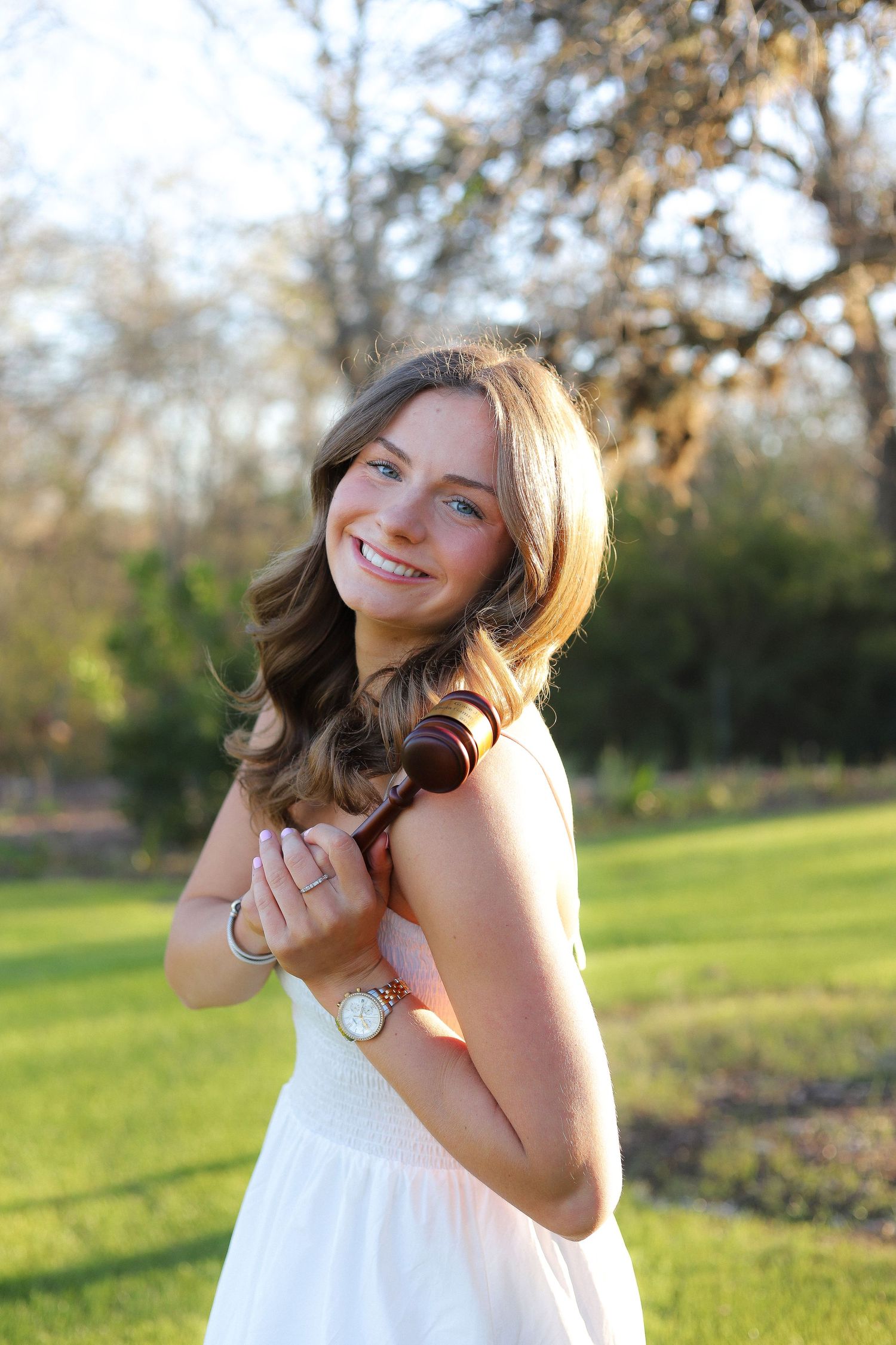 A series of joyful outdoor portrait shots in white dress against a sunlit grassy background.