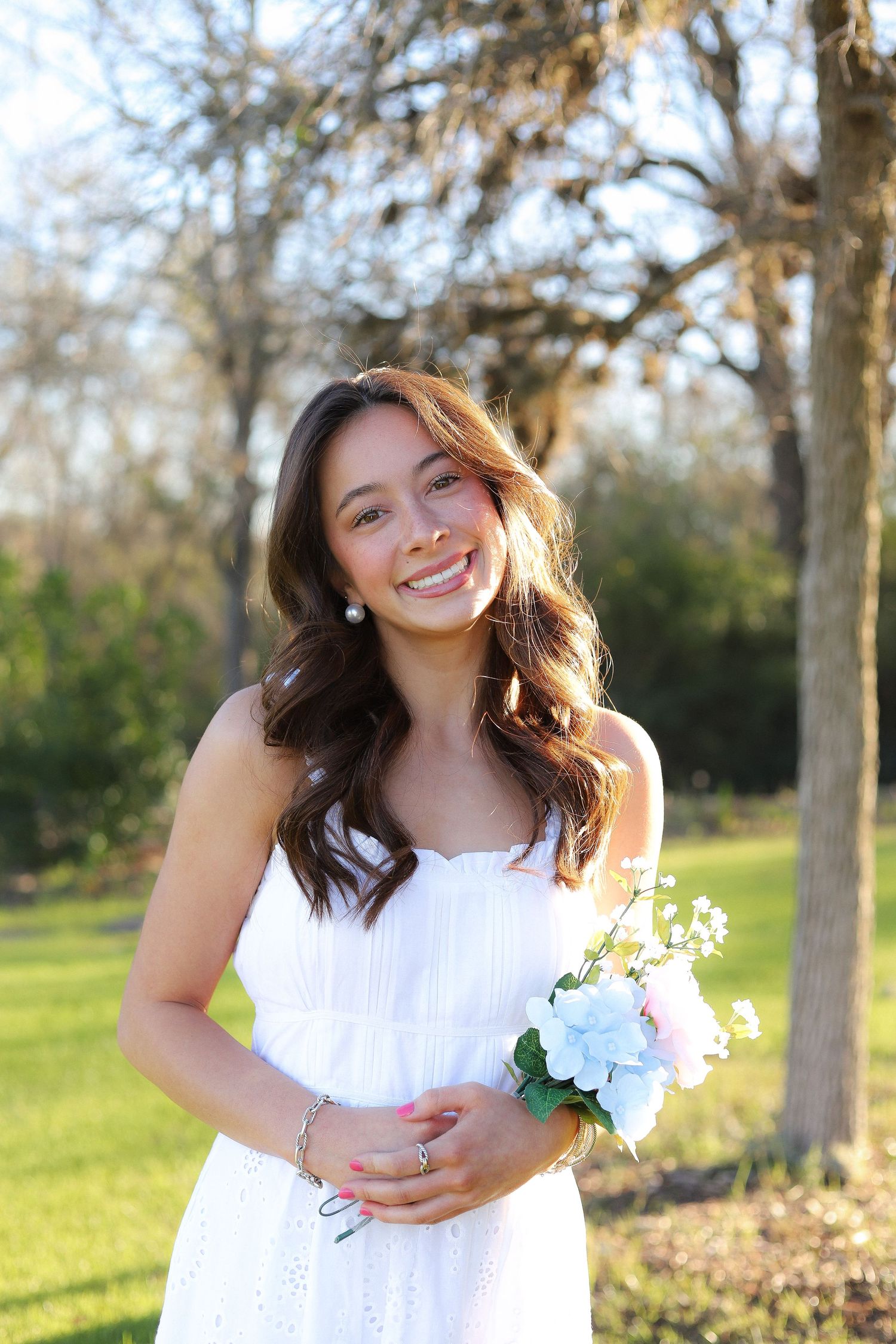 A series of outdoor portraits in a park with sunlit trees and grass in the background.