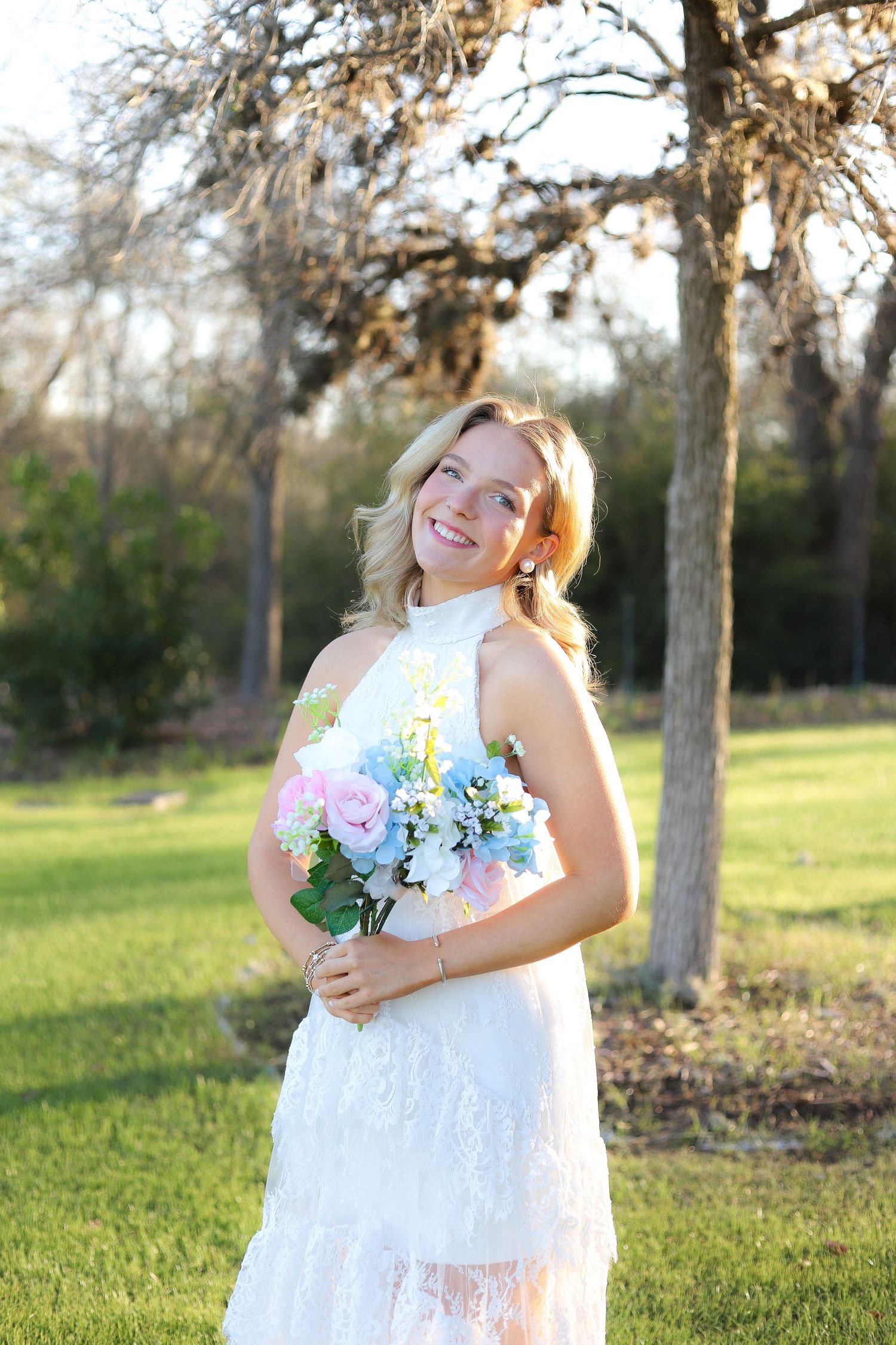 A series of candid moments captured in a white lace dress holding a spring bouquet in a sunny park setting.