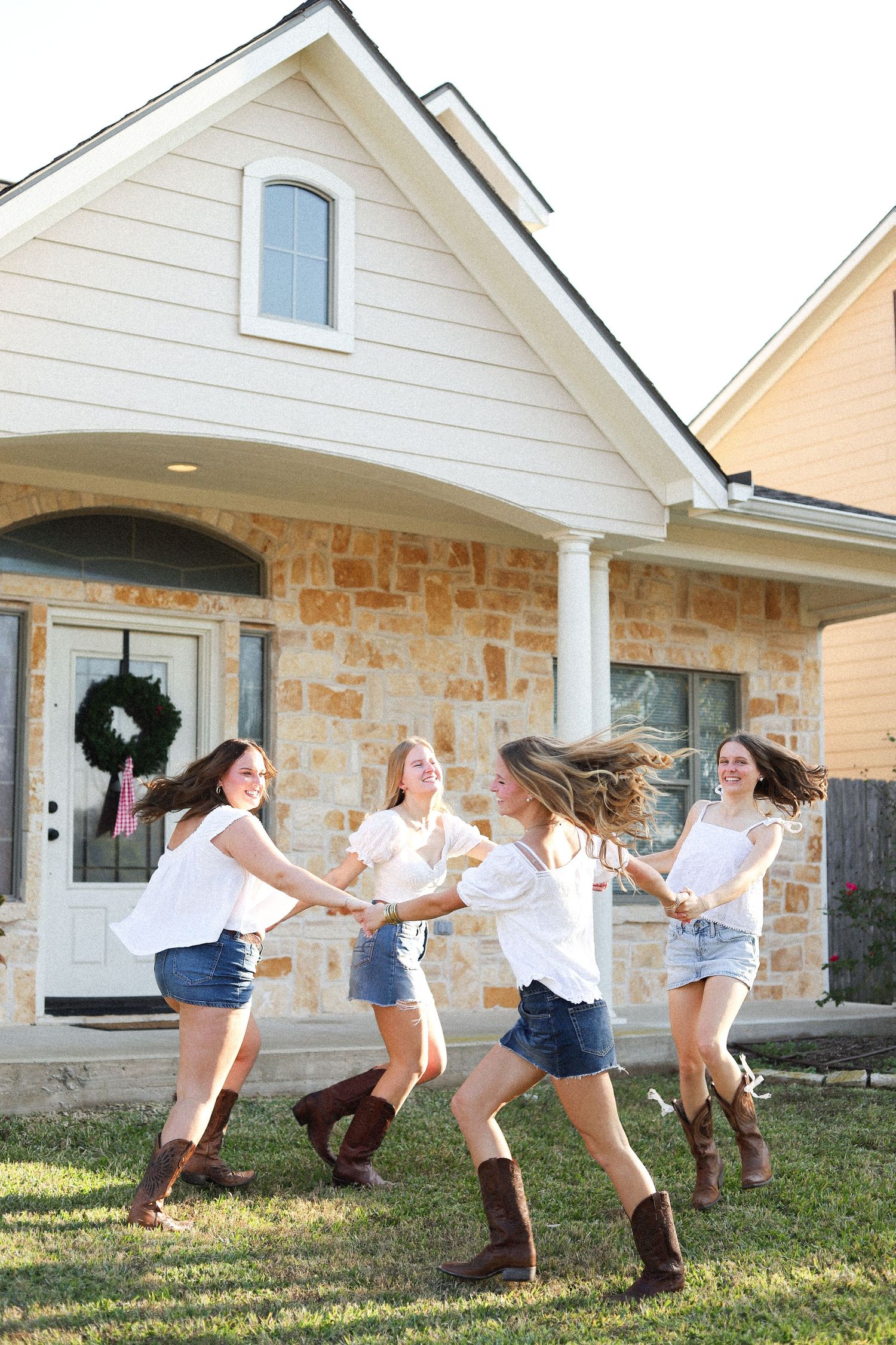 Action shots of friends jumping and playing in front of a stone house exterior.