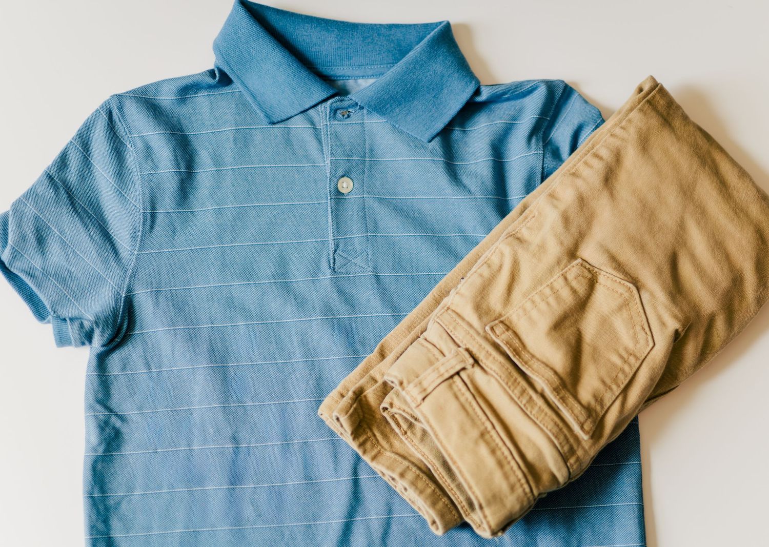 Boy’s outfit with blue polo shirt and khaki pants styled for family photo session
