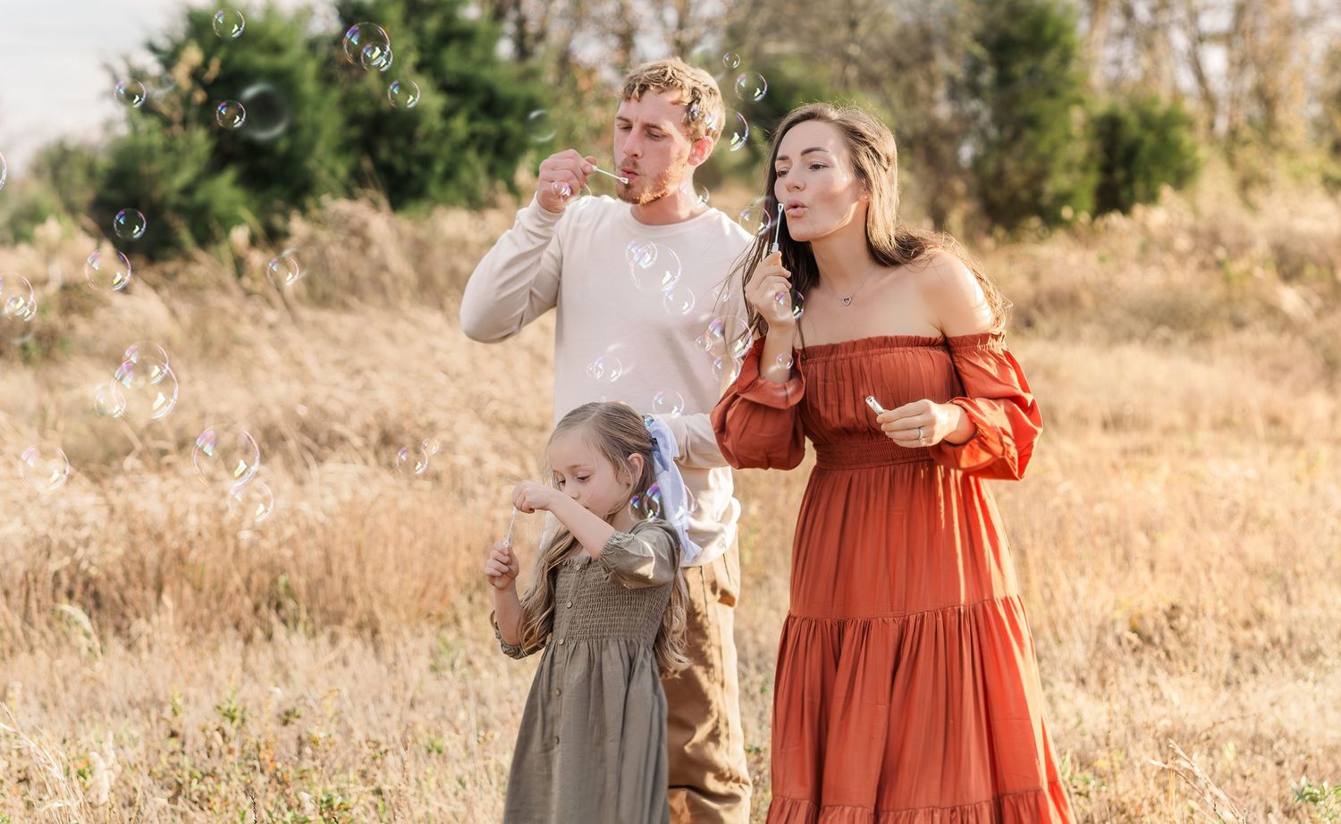 Golden hour family photography session in Murfreesboro Tennessee with parents and child playing outdoors