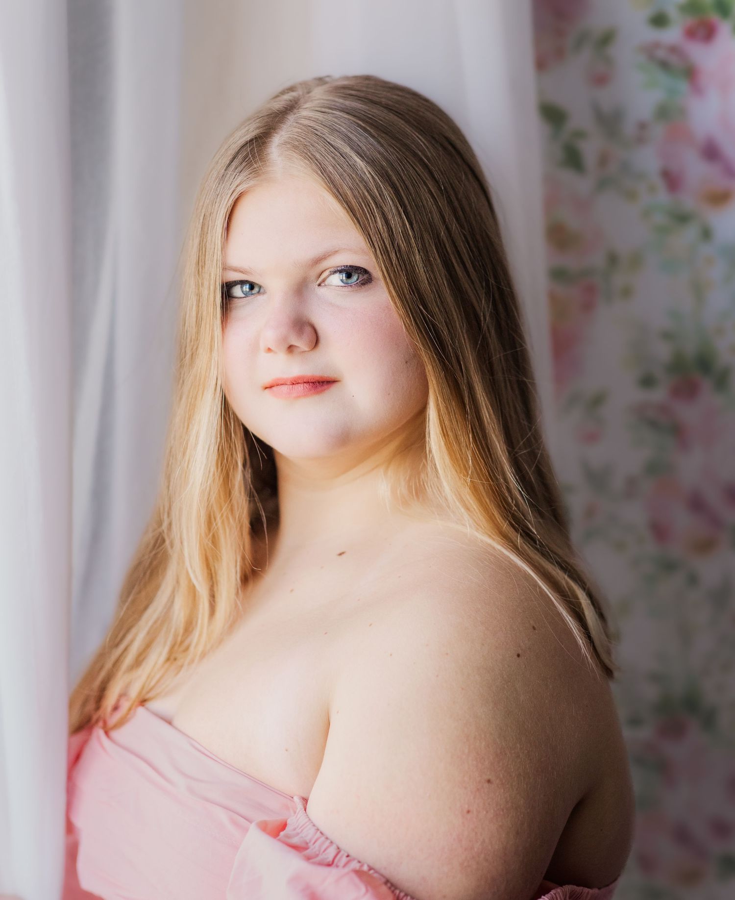 Teen girl with long blonde hair wearing a soft pink off-the-shoulder top, photographed in Murfreesboro, Tennessee.