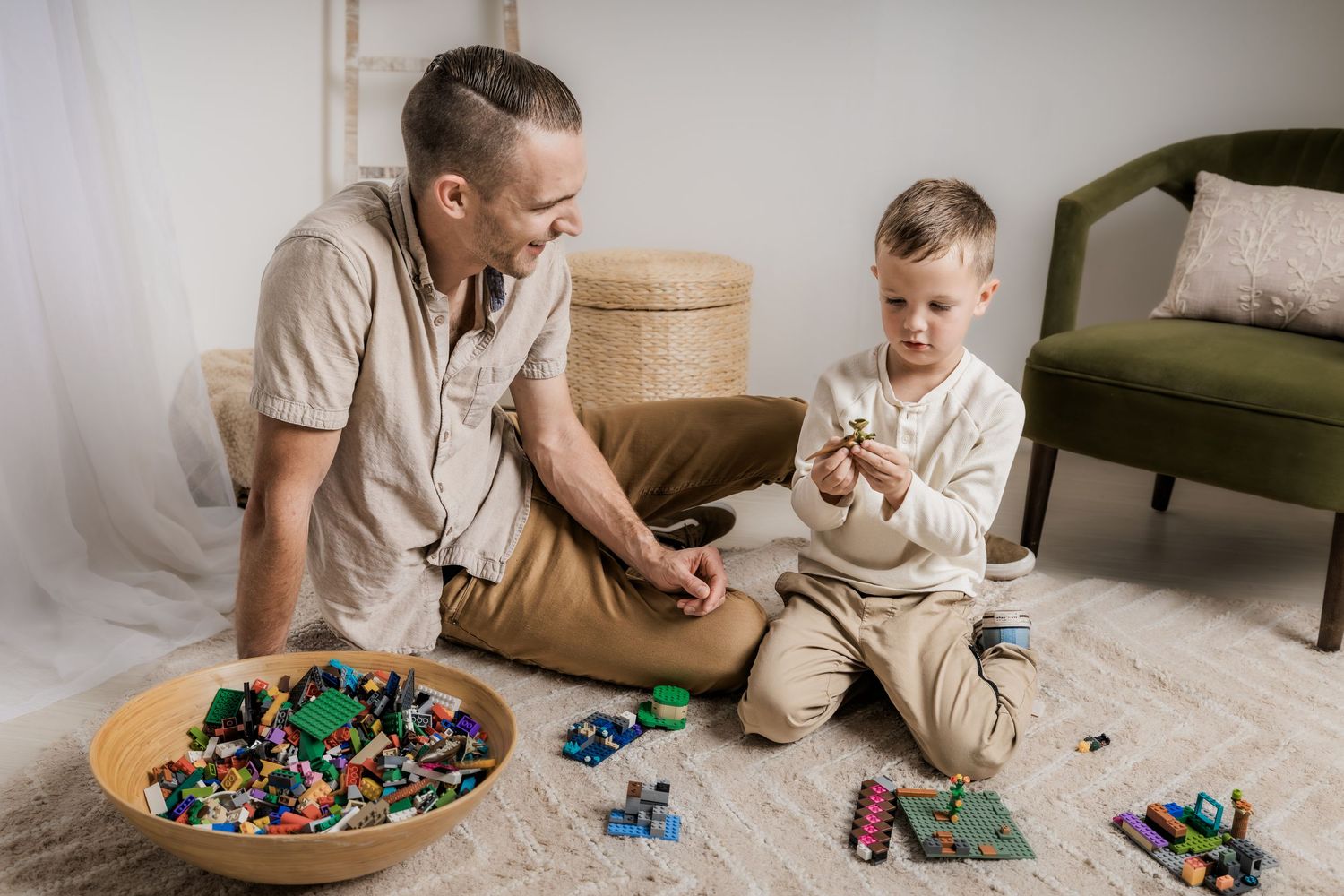 Father and young son playing with building blocks during a relaxed lifestyle family photography session in Murfreesboro, Tennessee.