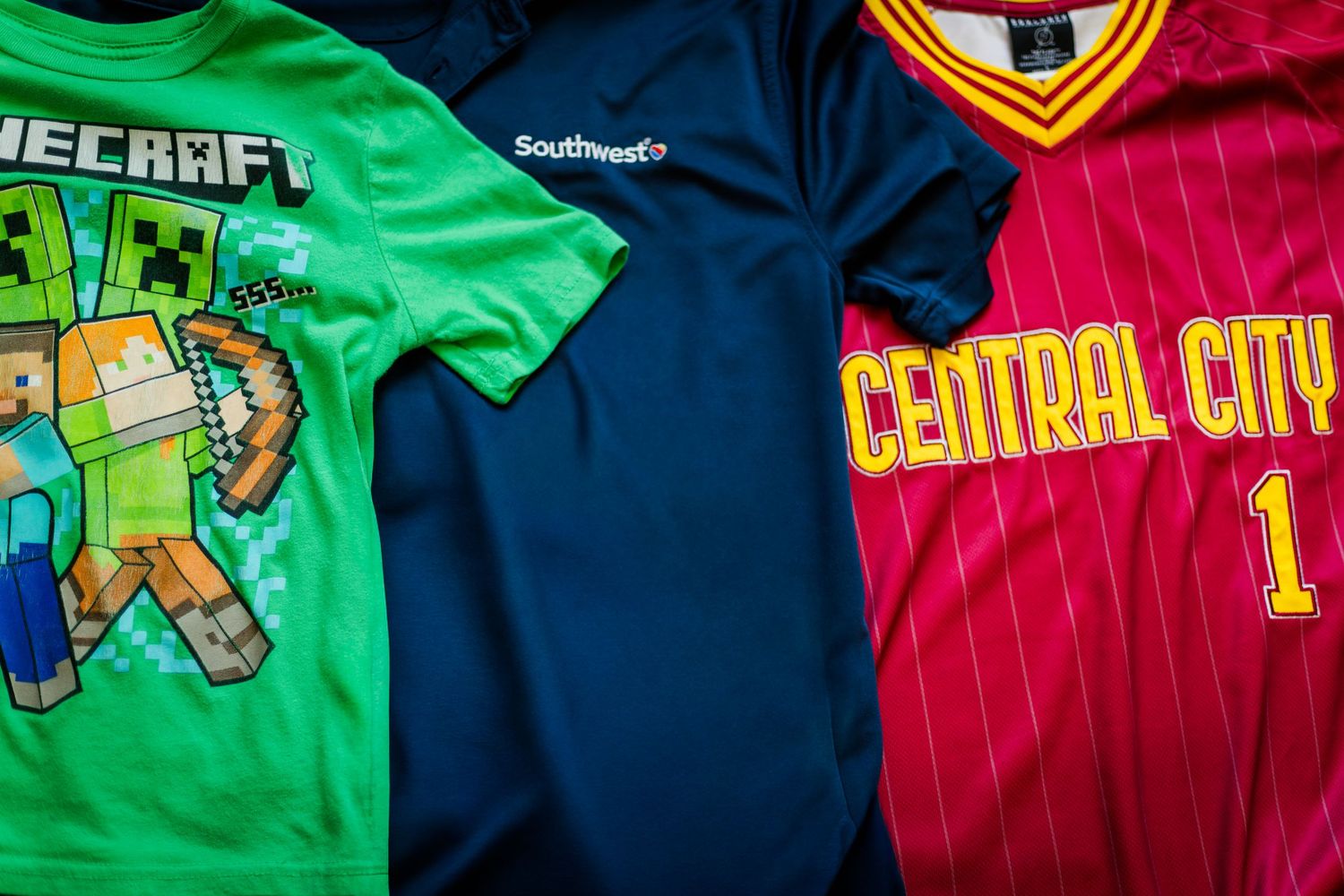 Clothing with bold logos and graphics including branded shirts and sports jerseys that can be distracting in family photos