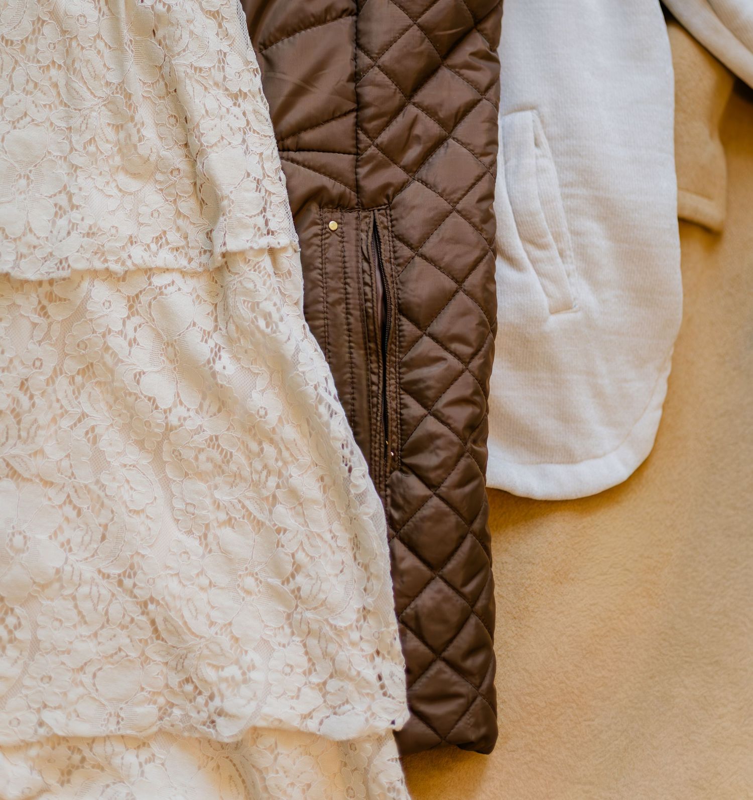 Soft neutral family photo outfits with lace, quilted texture, and warm tones styled for a Murfreesboro TN photography session