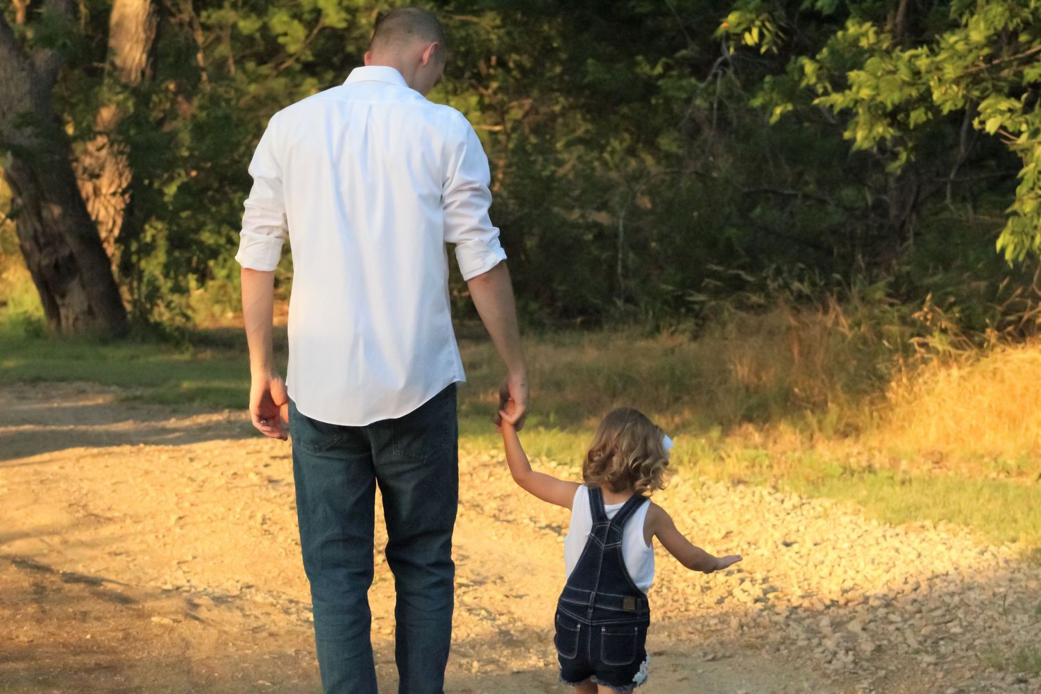Father holding daughter’s hand during family photography session in Murfreesboro Tennessee