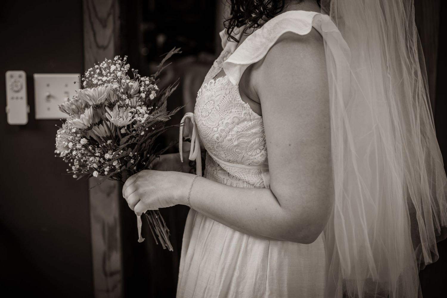 Black and white bridal portrait of a bride holding a wildflower bouquet during an intimate elopement in Murfreesboro, Tennessee.