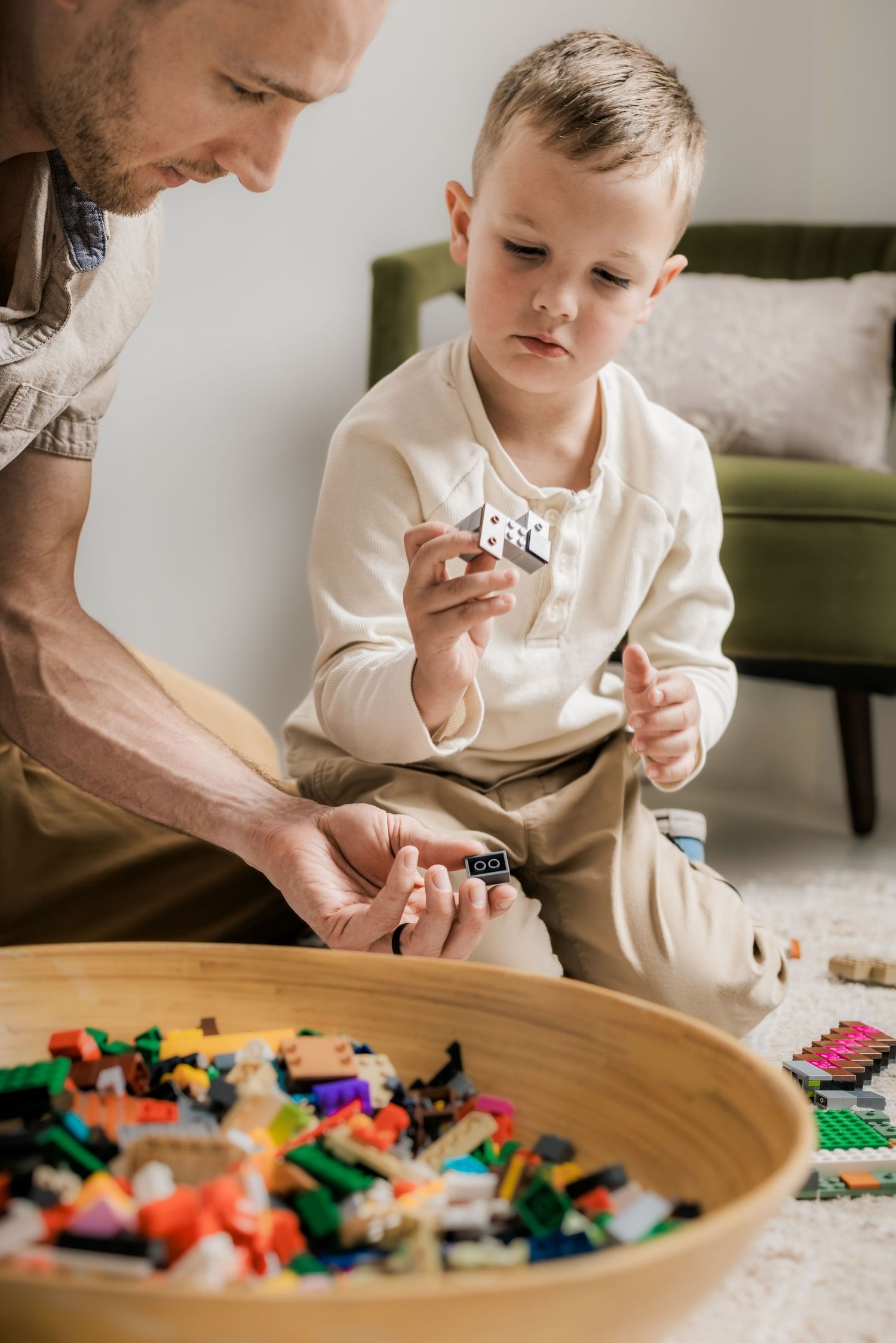 A father and son playing with building blocks together during an in-home family session in Murfreesboro, Tennessee