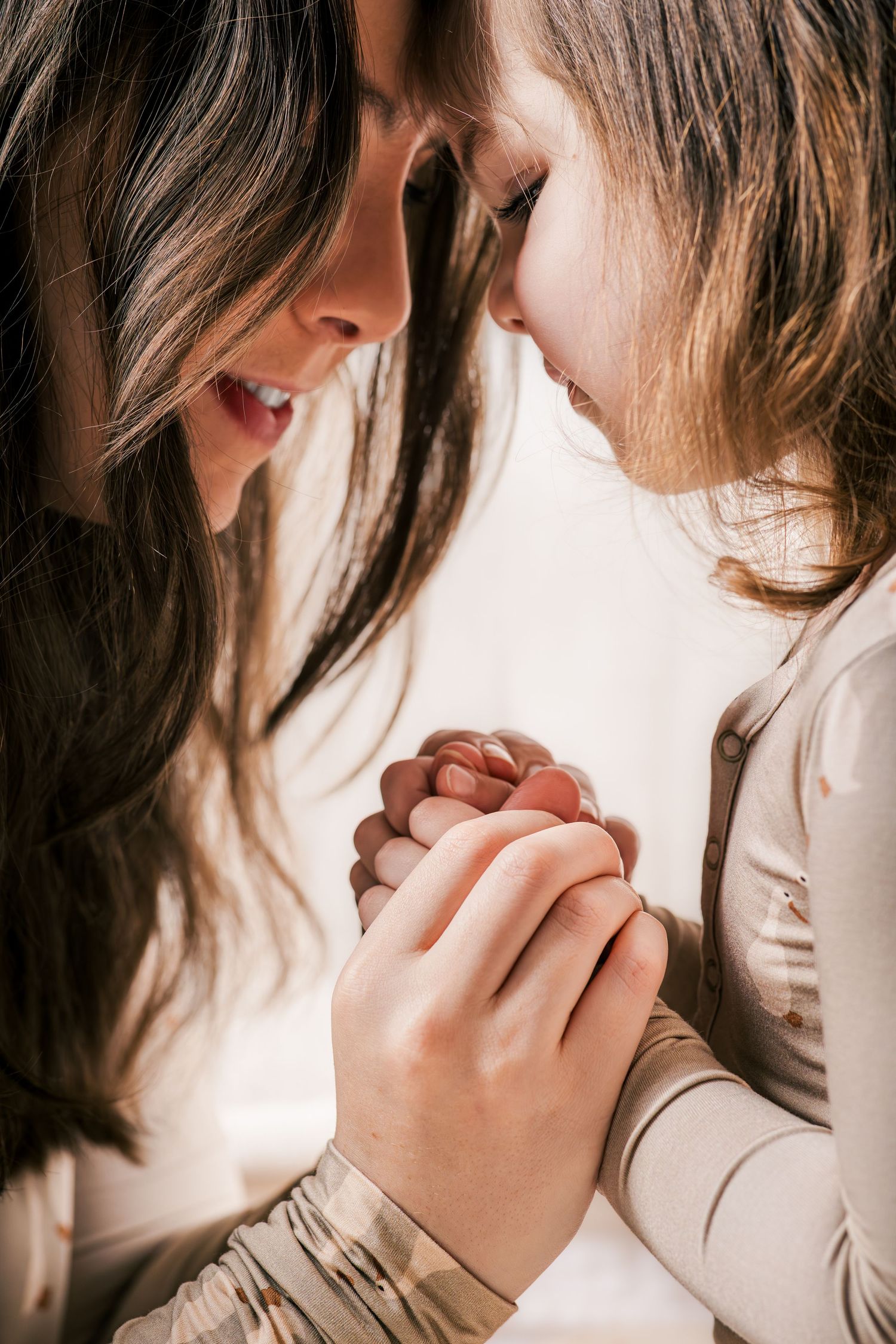 Two people share an intimate moment in soft lighting as they lean close together in a series of tender poses at a session in Murfreesboro.