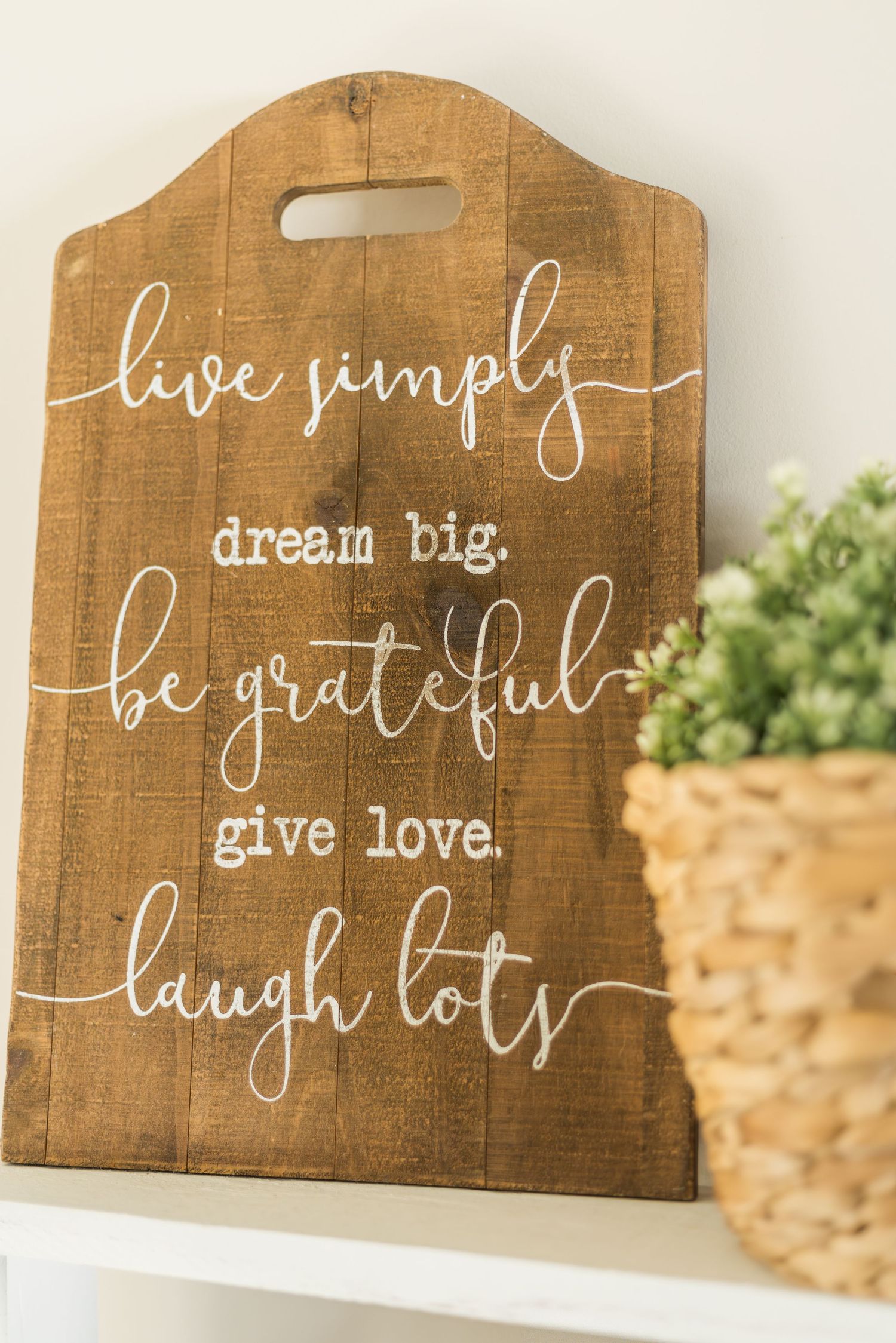 Wooden sign with inspirational quote inside Cloudline Photography studio in Murfreesboro Tennessee