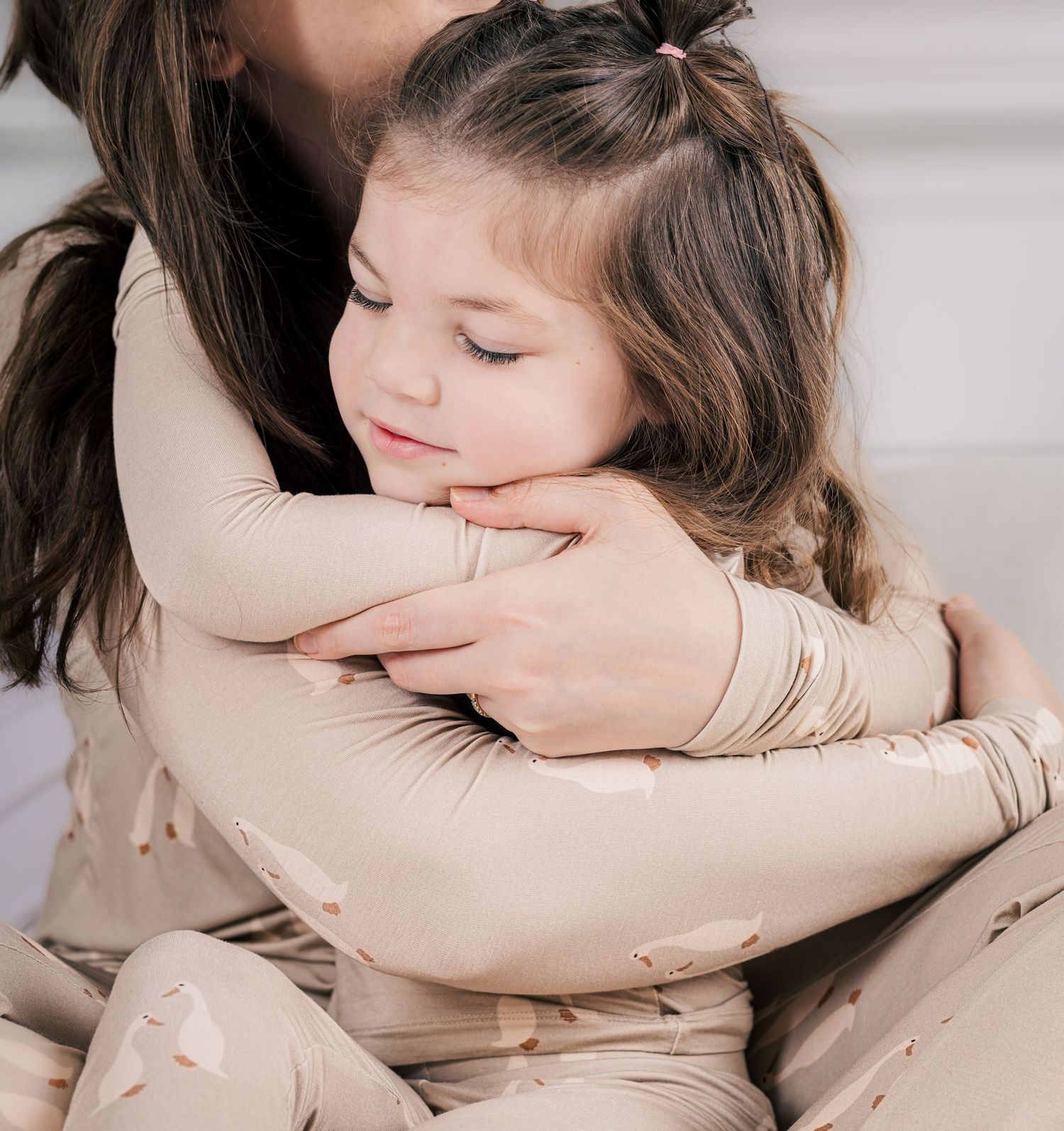 Mother embracing her young daughter during a warm lifestyle family photography session in Murfreesboro, Tennessee.