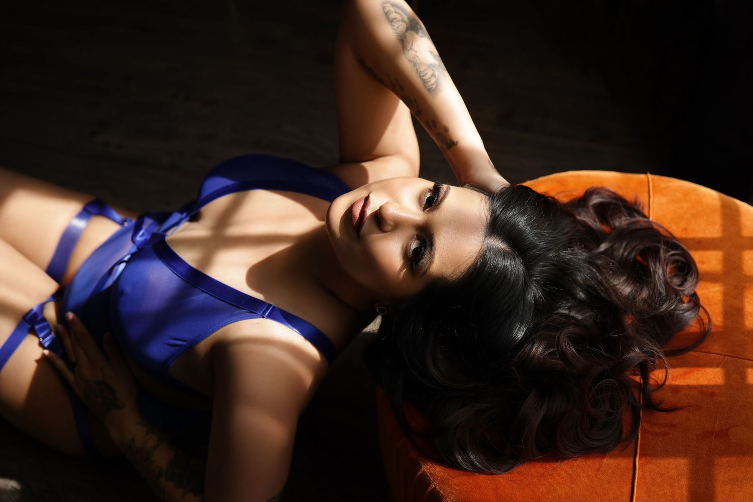 Elegant boudoir portrait of a woman in blue lingerie in luxury photo studio