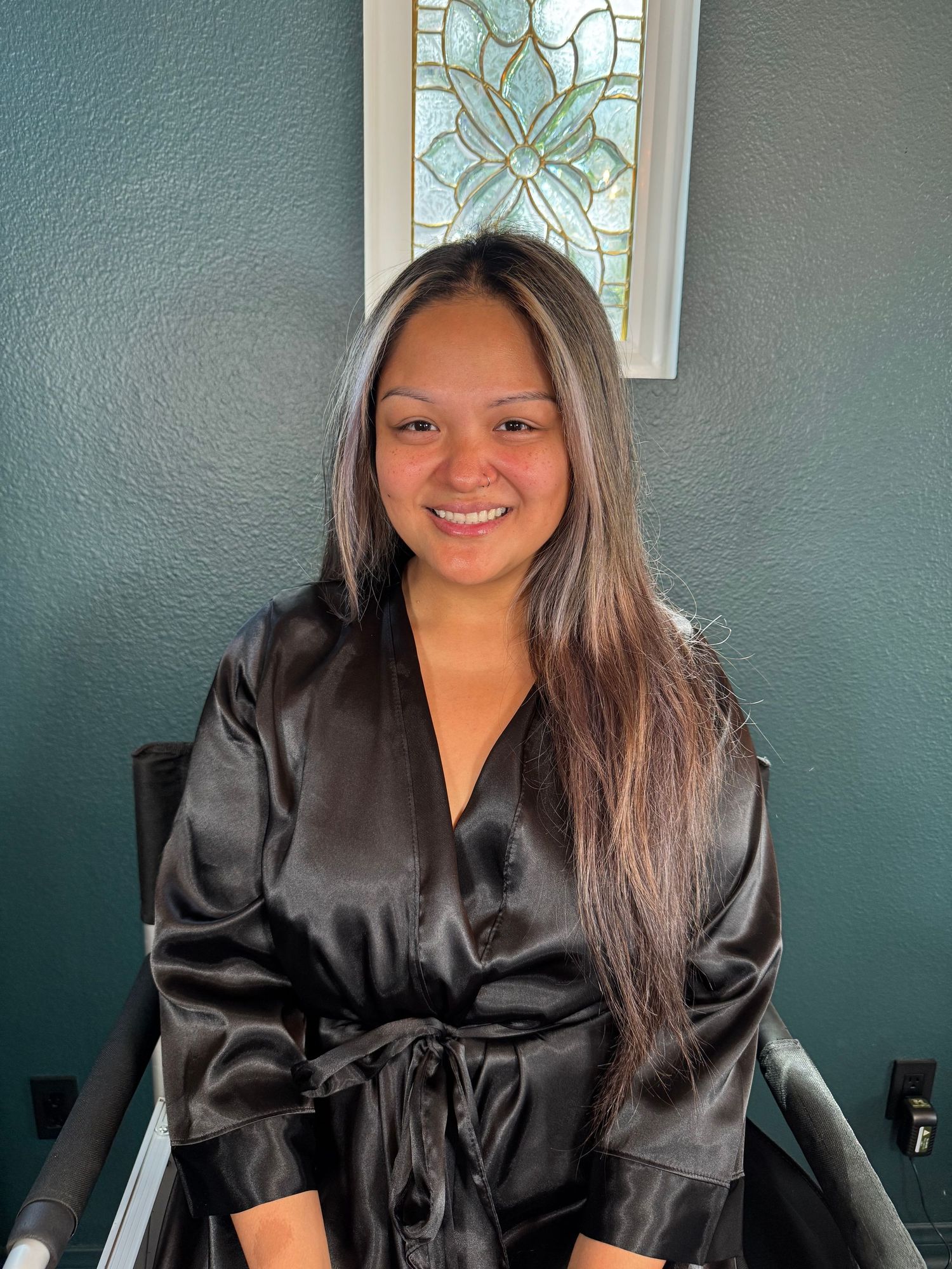 Before photo of a boudoir client in a black silk robe.