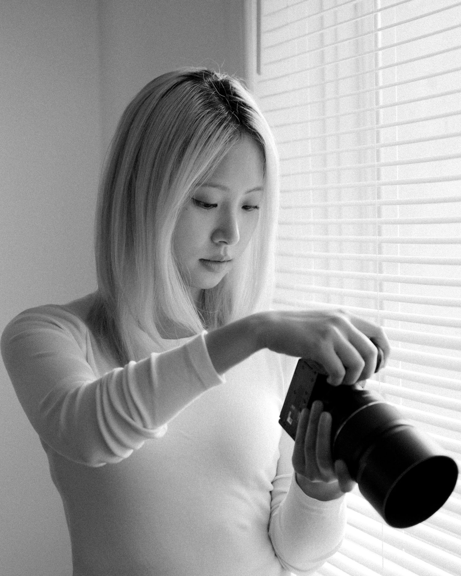 Black and white sequence showing someone drinking from a dark mug by a window.