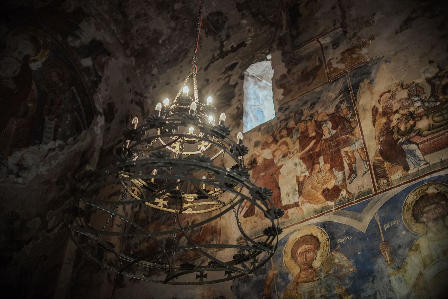 A panoramic view of ornate baroque ceiling frescoes depicting religious and mythological scenes in rich colors.