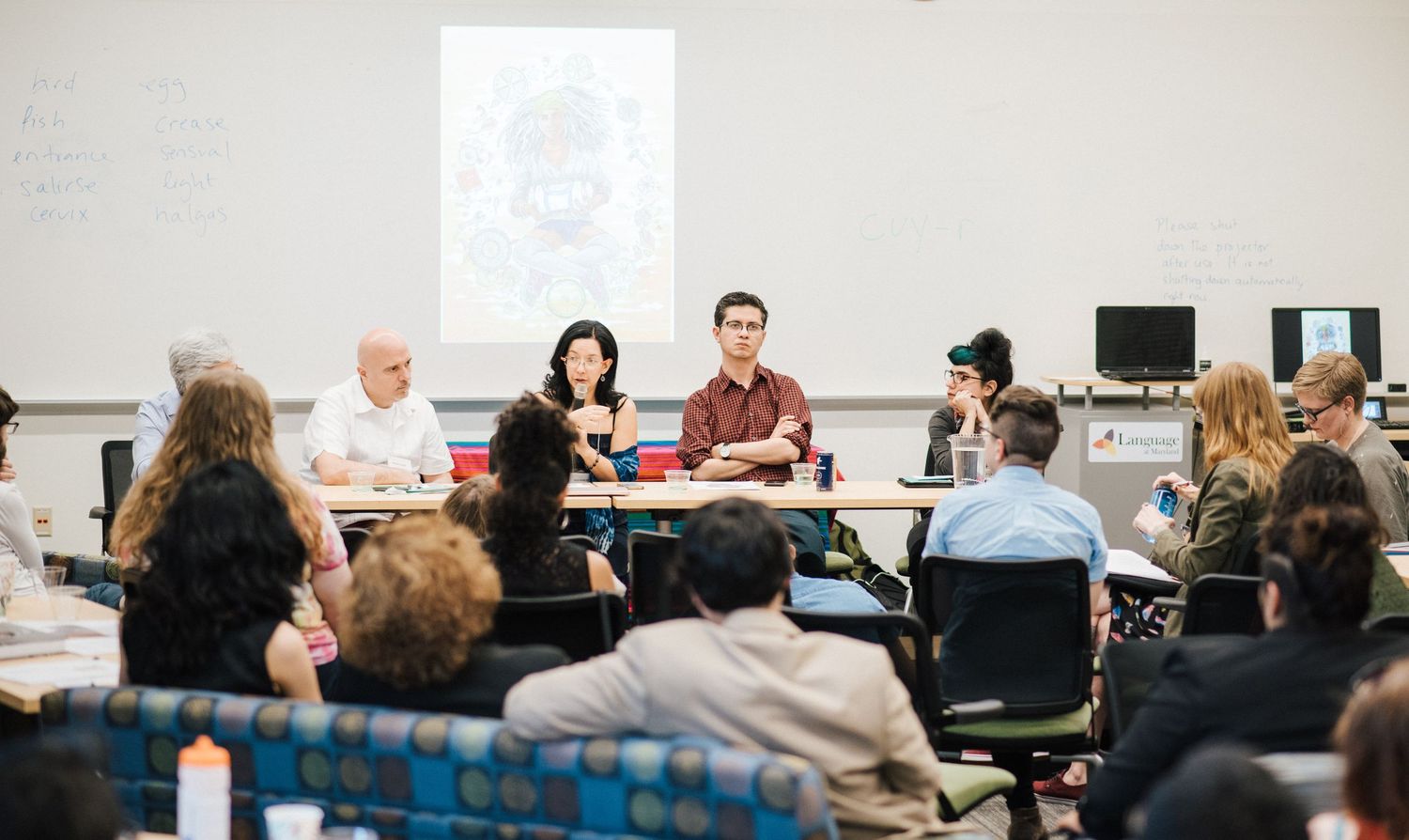 Students sitting in rows during a classroom presentation or workshop.