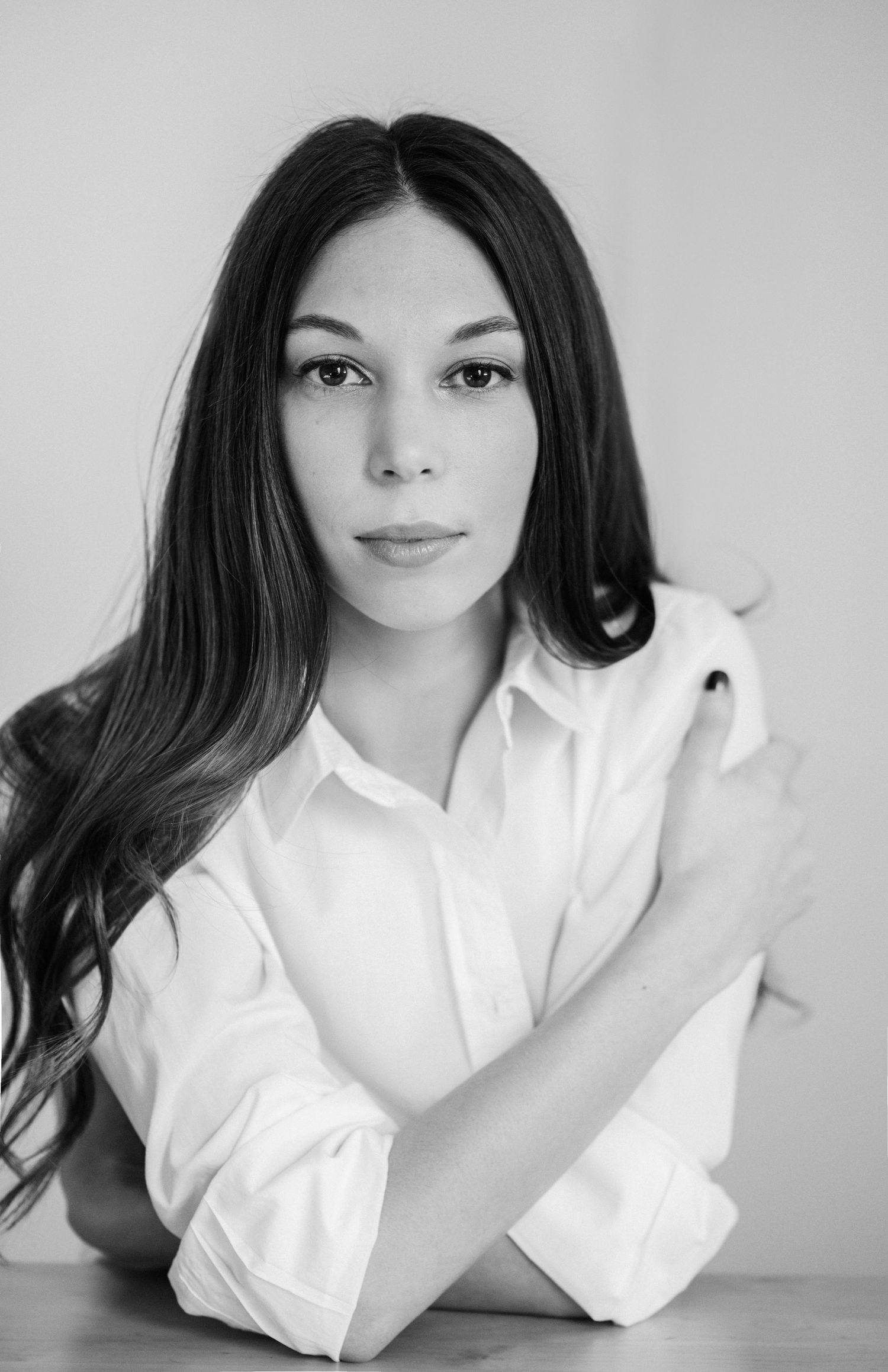 Classic black and white portrait series with white shirt against minimal background.