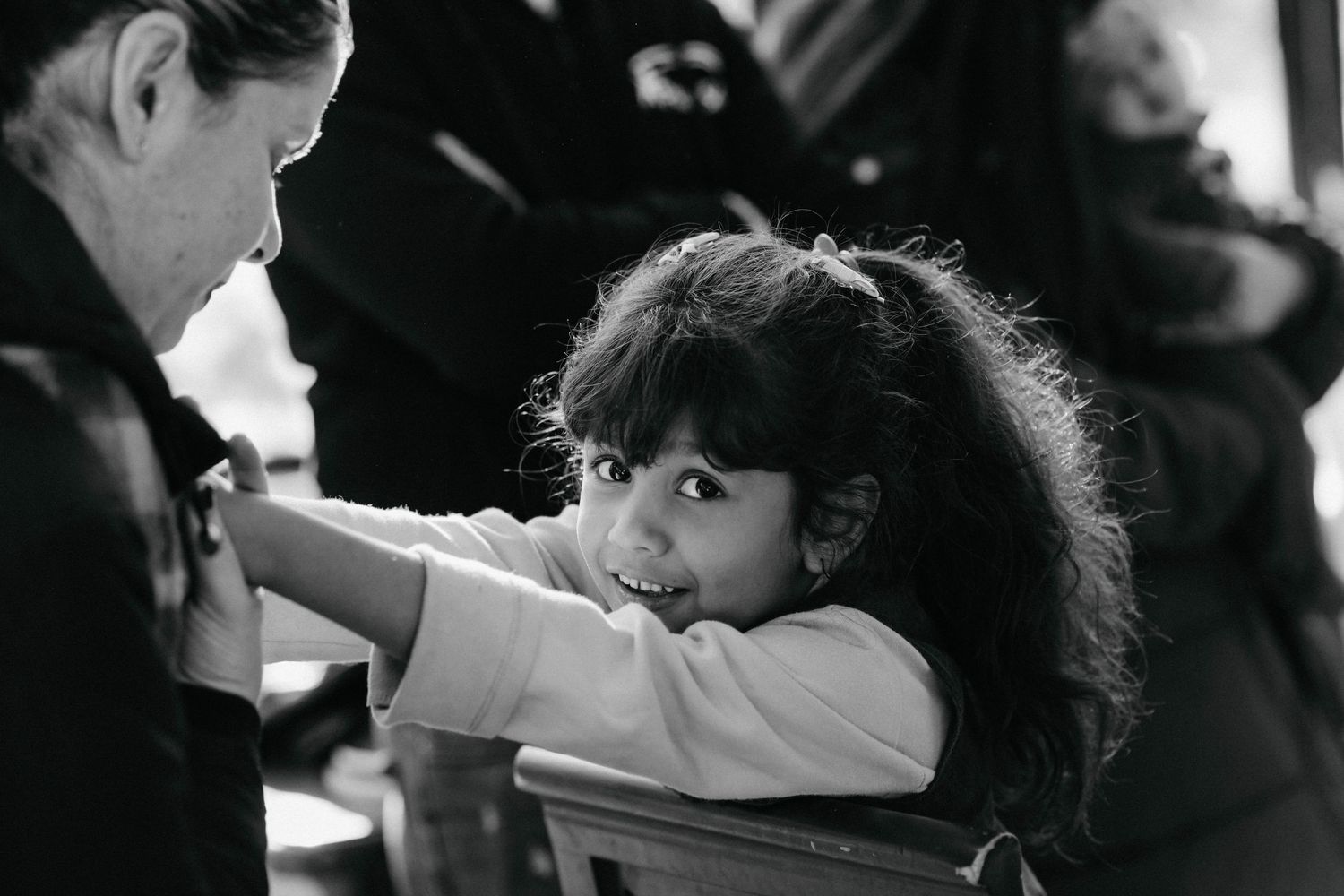 A black and white photo montage showing children in various candid moments at school.