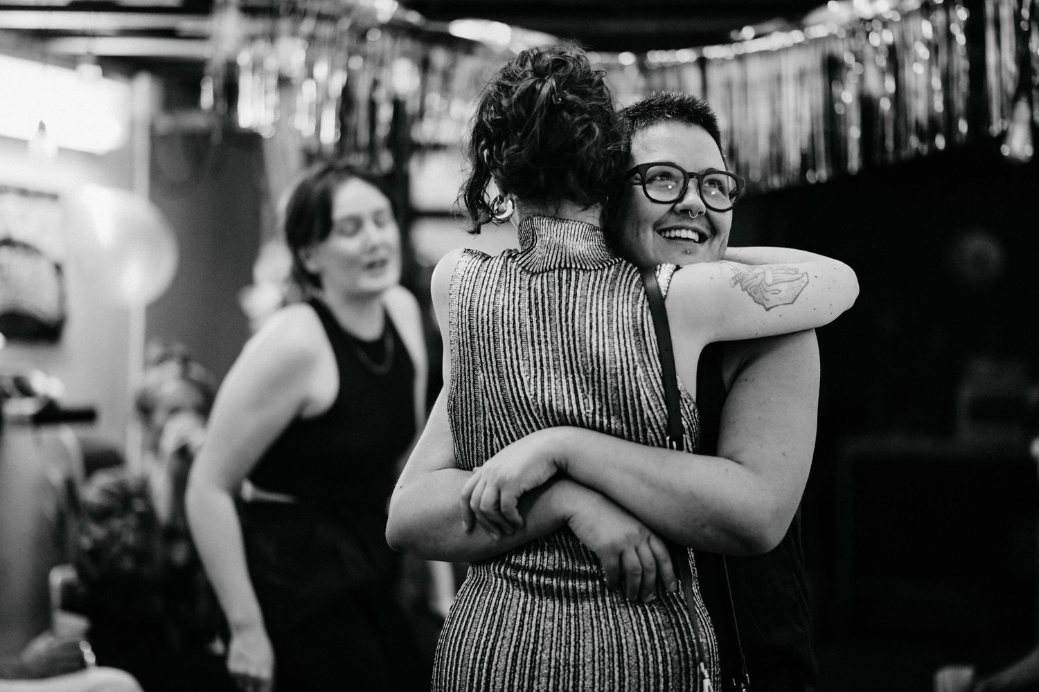 People sharing a joyful moment together in a casual indoor environment.