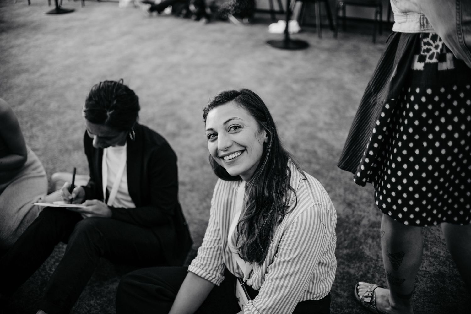 Casual gathering with person smiling during indoor group activity.