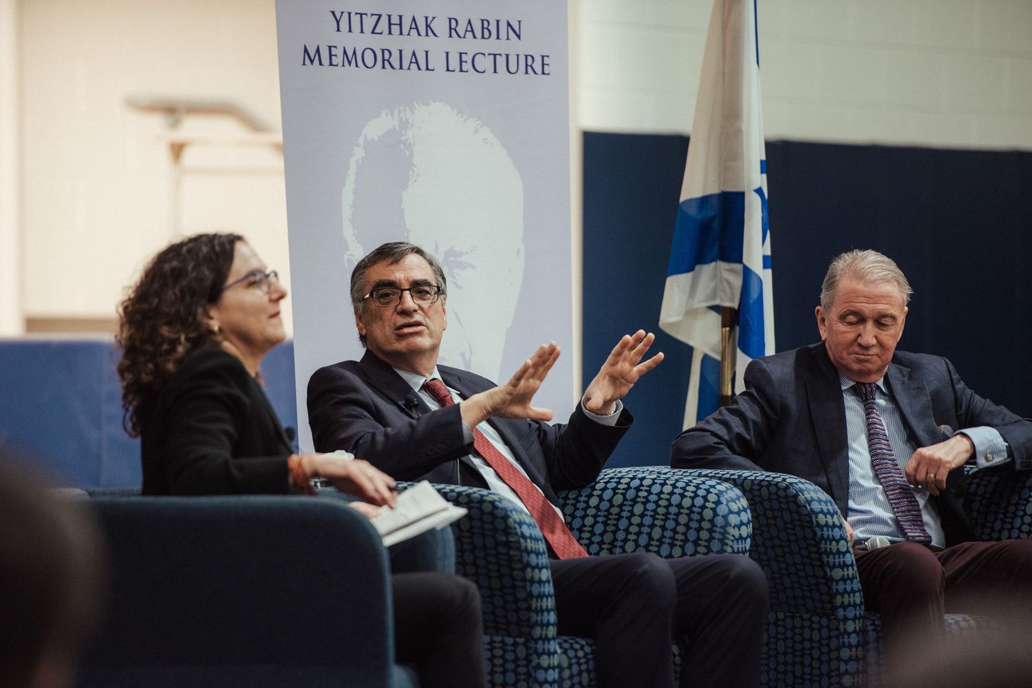 A sign displaying 'Yitzhak Rabin Memorial Lecture' in a conference setting.
