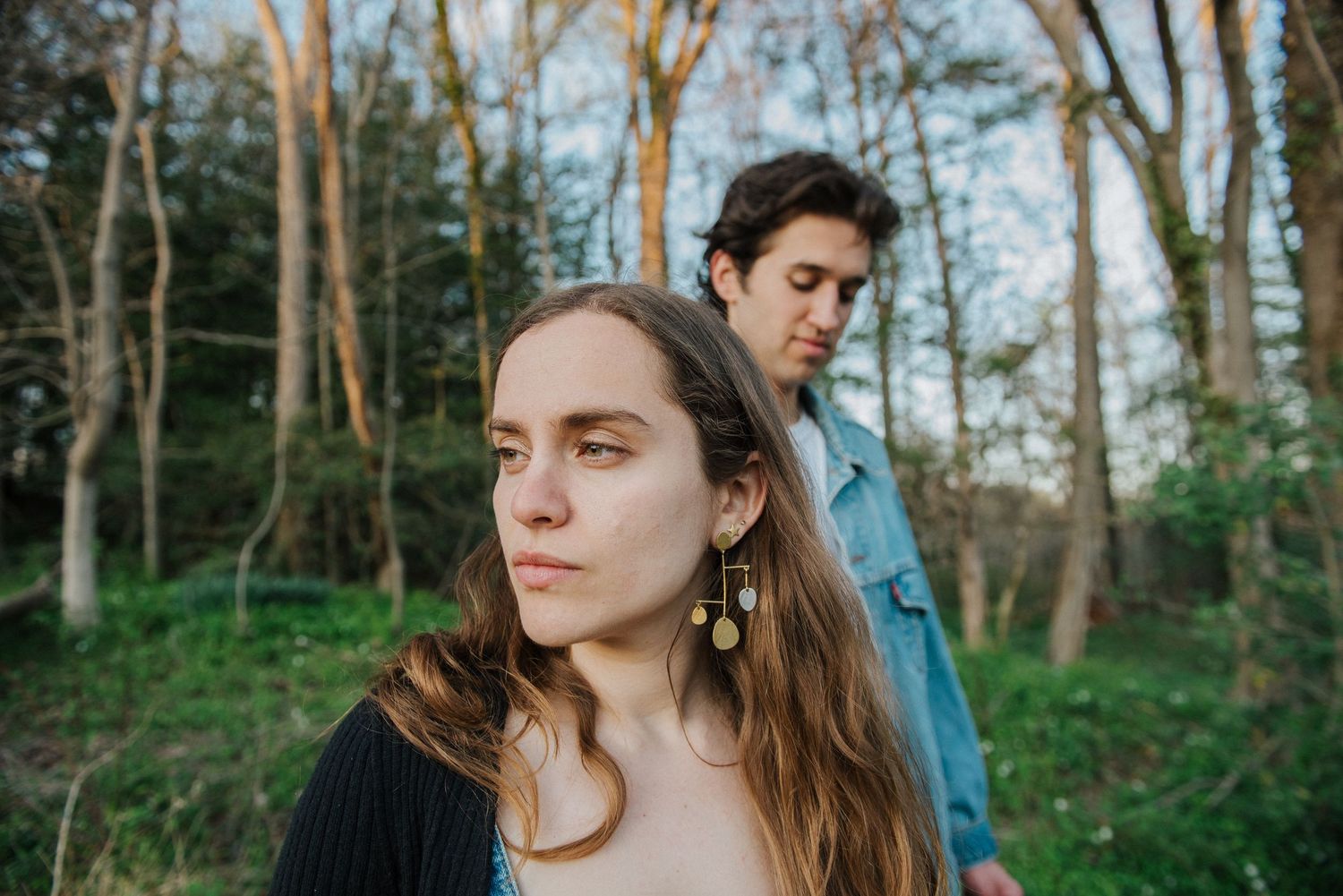 A series of artistic outdoor portraits in a wooded setting with natural lighting and soft earth tones.