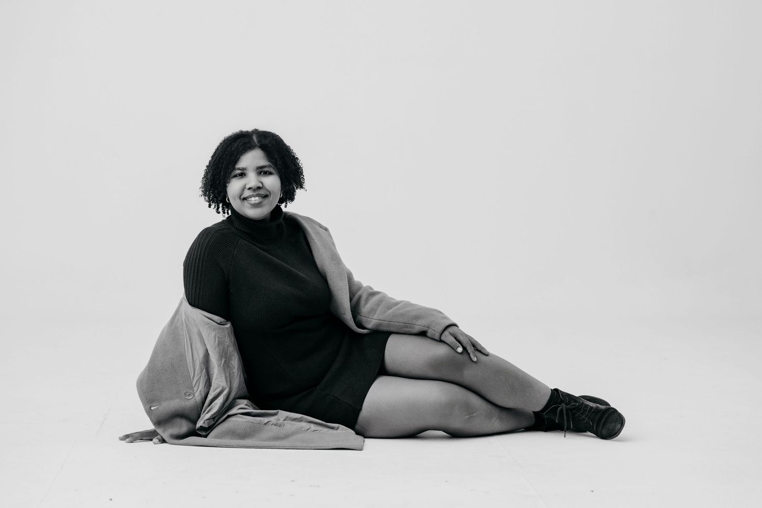 Four black and white photographs showing someone lying on the floor in different relaxed poses.