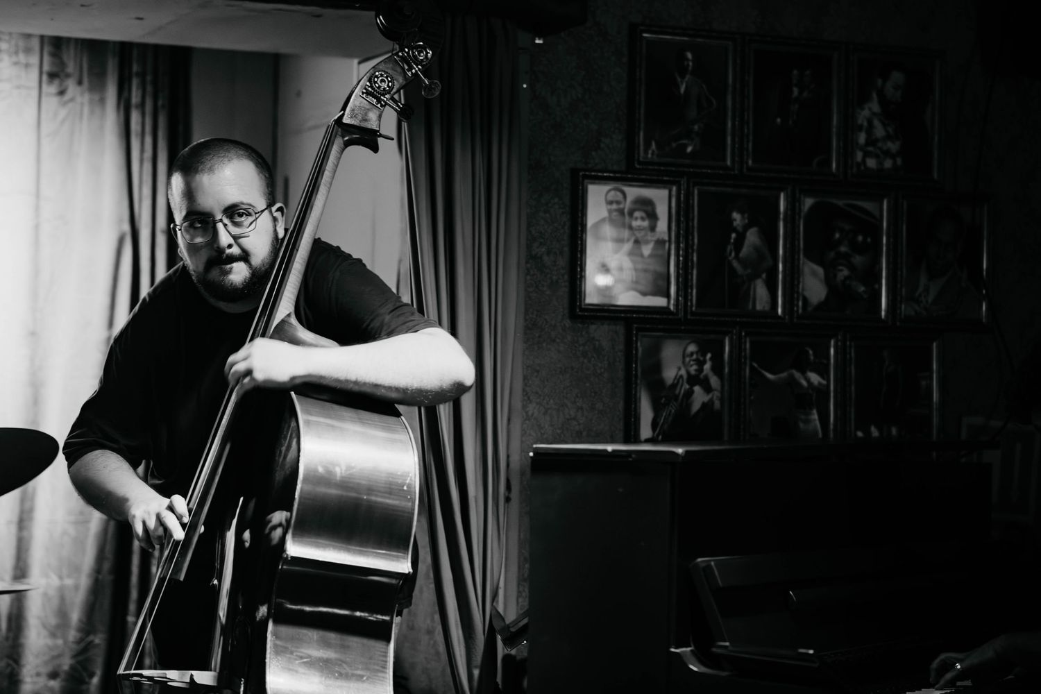 Musicians playing instruments in a dimly lit jazz club atmosphere.
