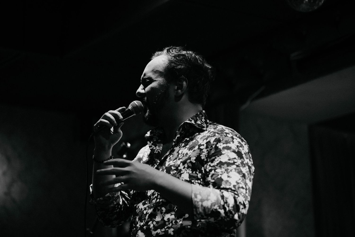 Black and white photo of musicians performing in an intimate venue setting.
