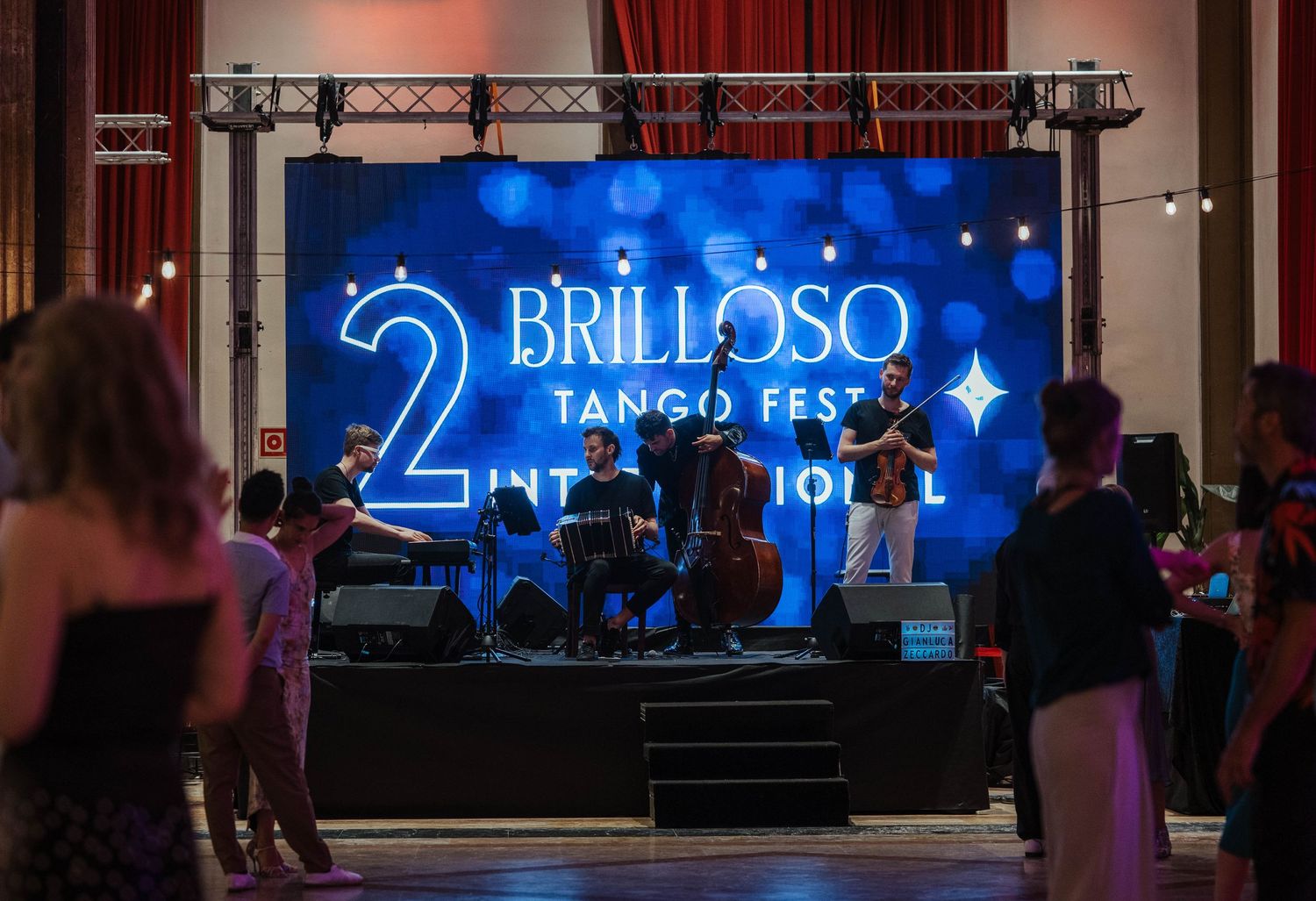 Live band performs at the 2nd Brilloso Tango Fest International event on a blue lit stage.