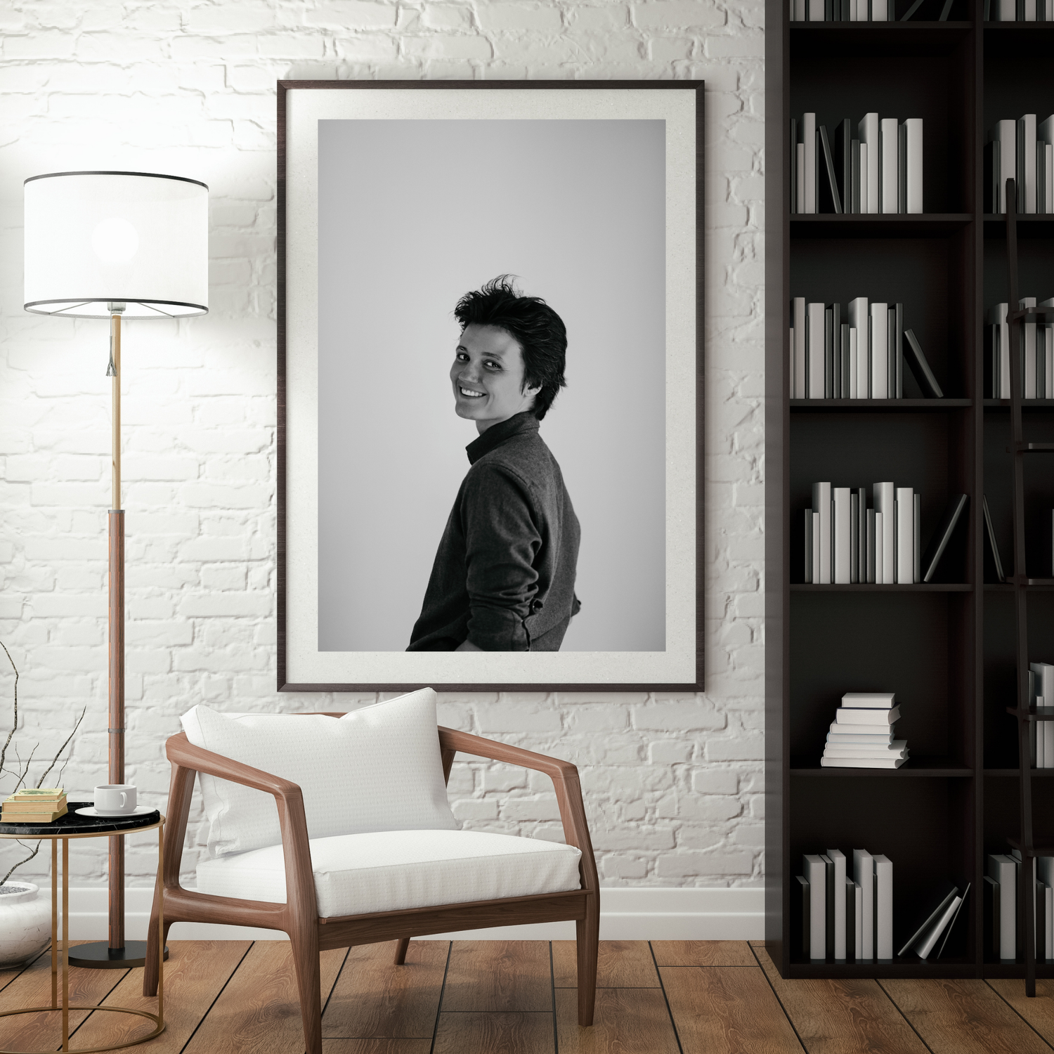 Modern living room interior with white brick wall, dark bookshelf, floor lamp and minimalist black and white artwork.