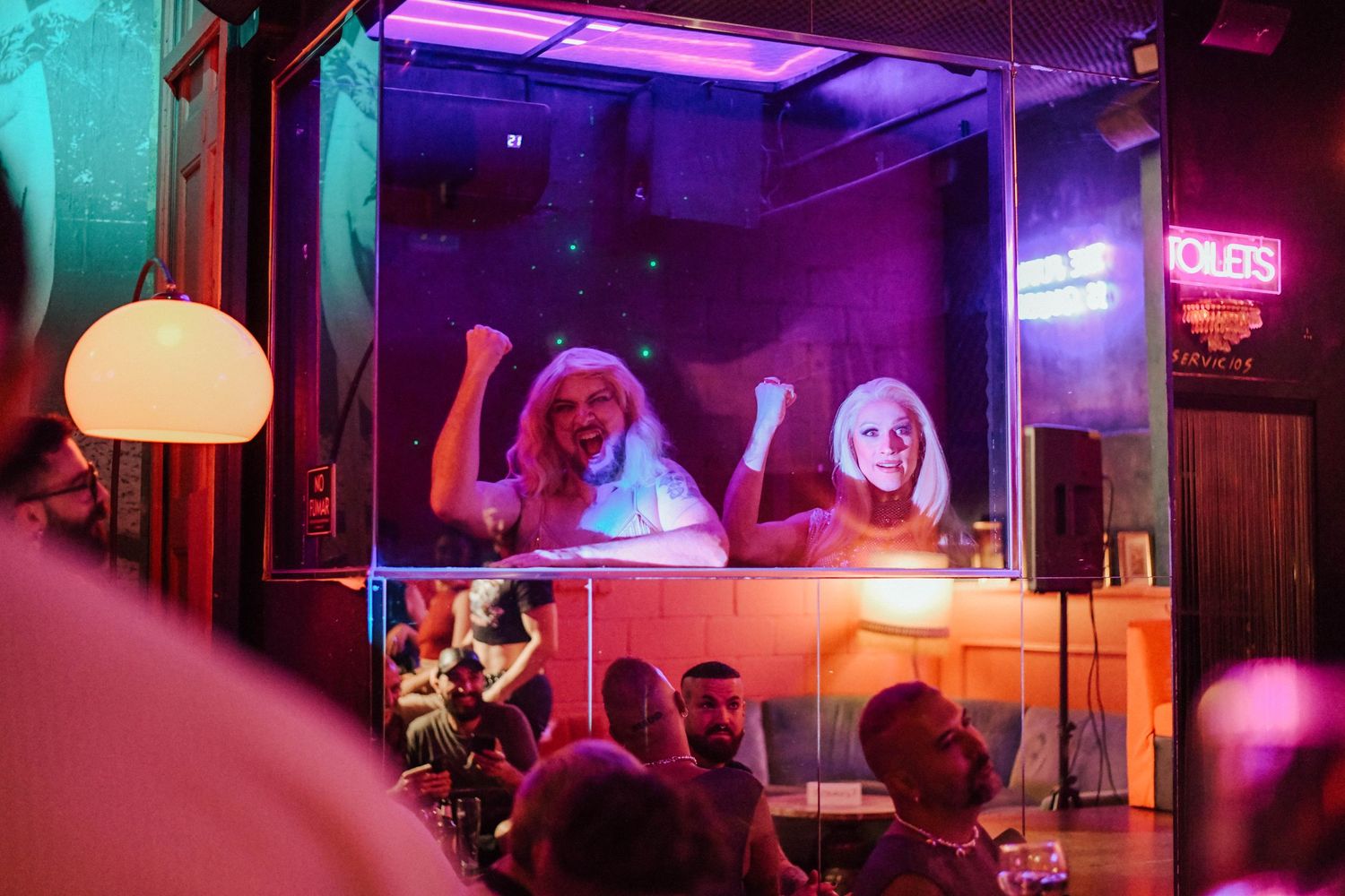 Vibrant nightclub interior with neon purple and turquoise lighting creating an atmospheric ambiance.