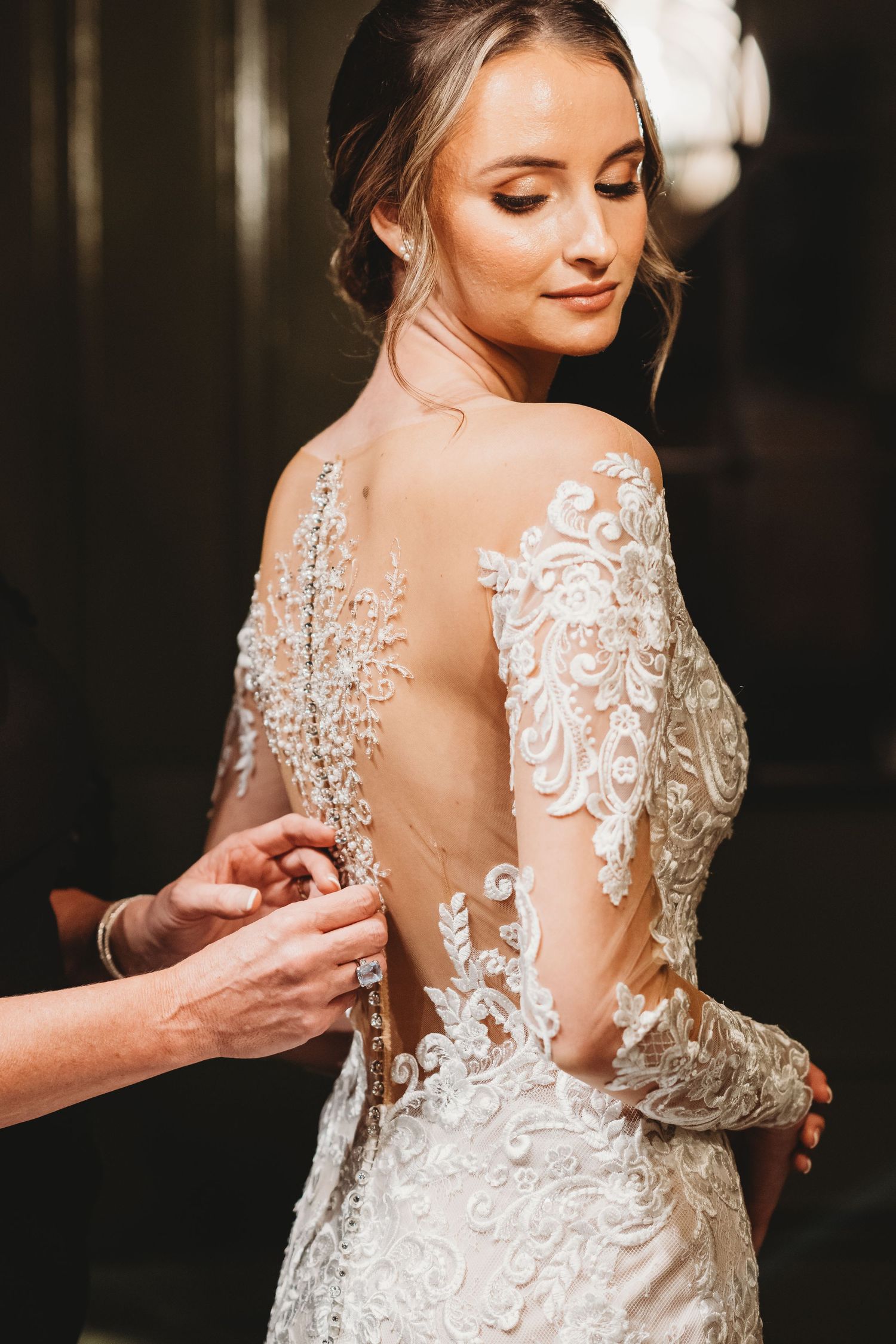 Bride getting dressed with mom during relaxed wedding morning