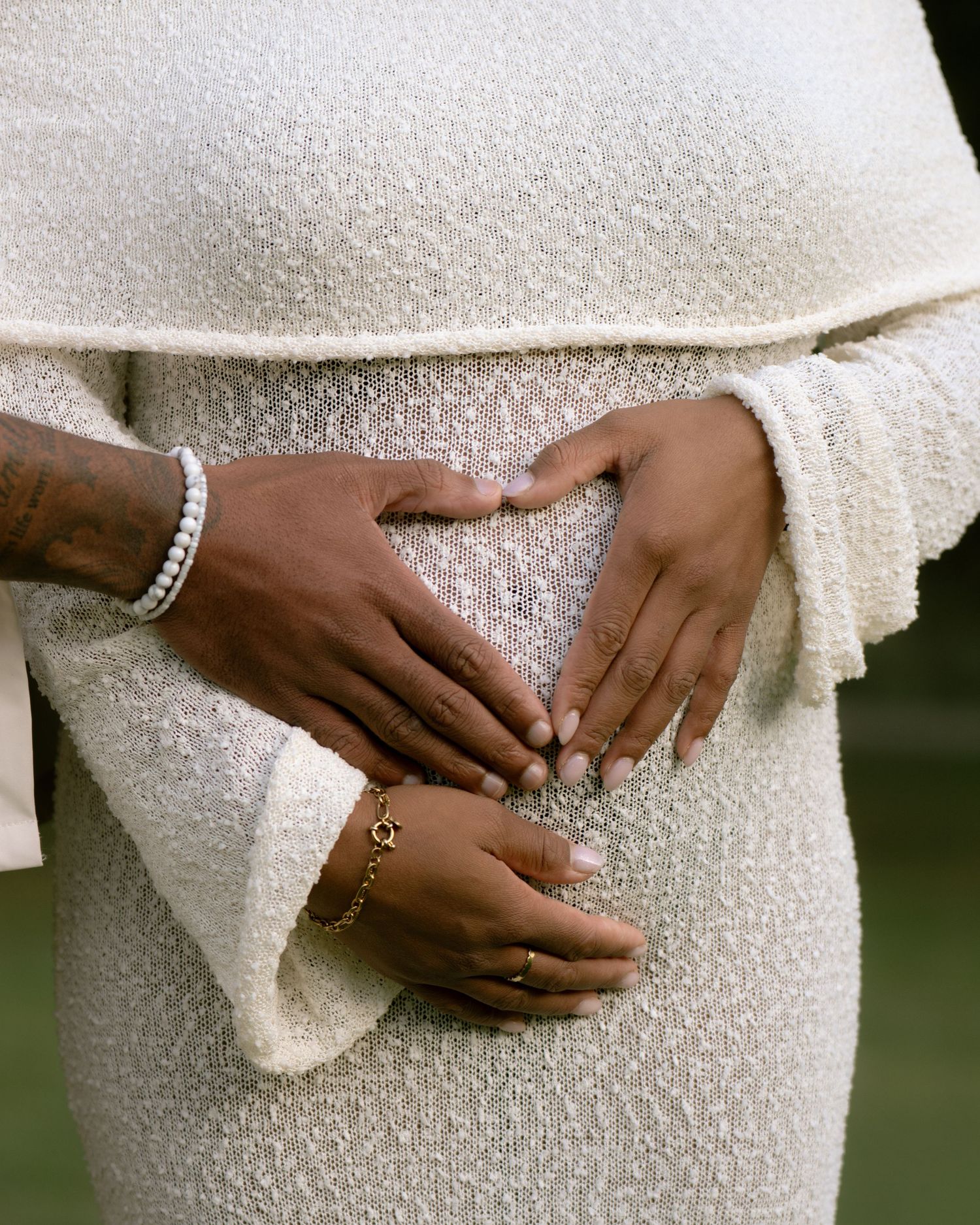 Close-up shots of hands resting on a textured white dress, showing delicate jewelry details.