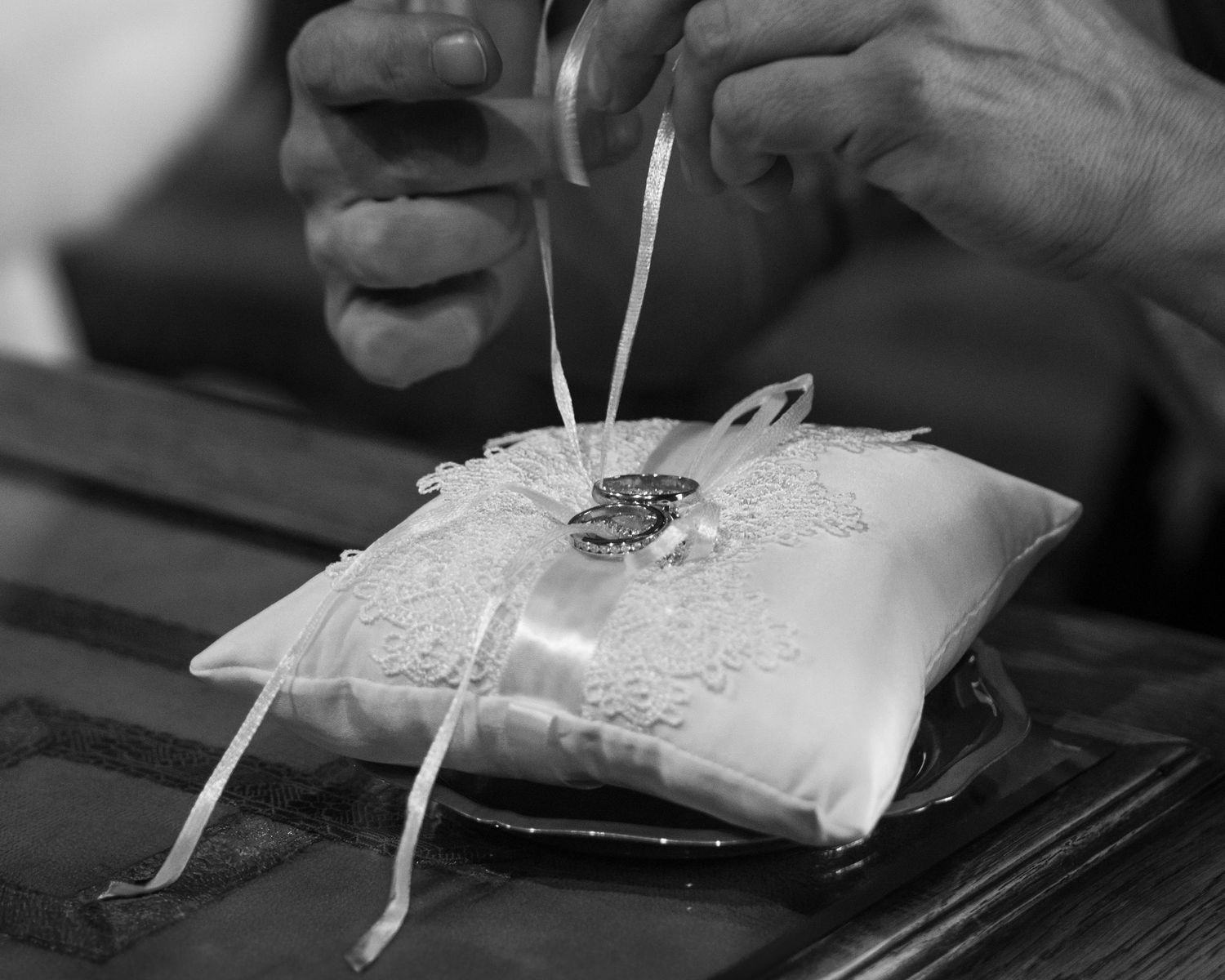 Sequence of black and white photos showing a cigarette pack being opened and cigarettes being removed.