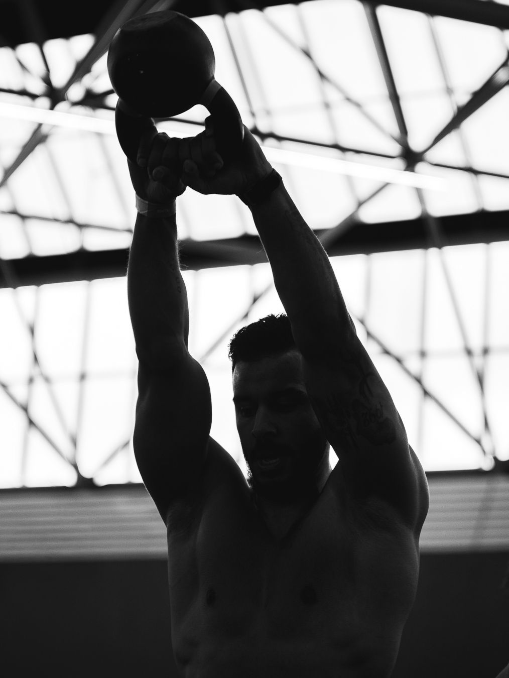 Black and white photo sequence showing a silhouetted figure performing a backflip against a bright background.