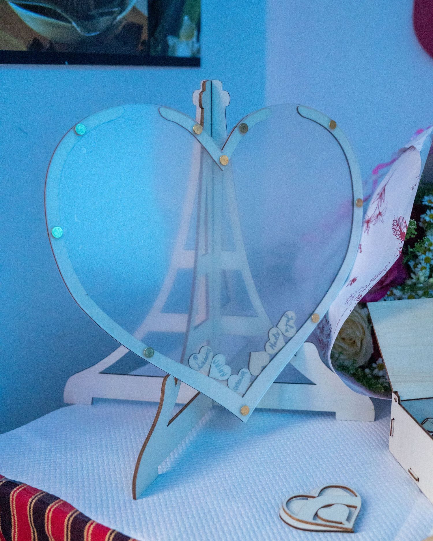A series of photos showing the assembly process of a white paper or cardboard pop-up windmill craft project.