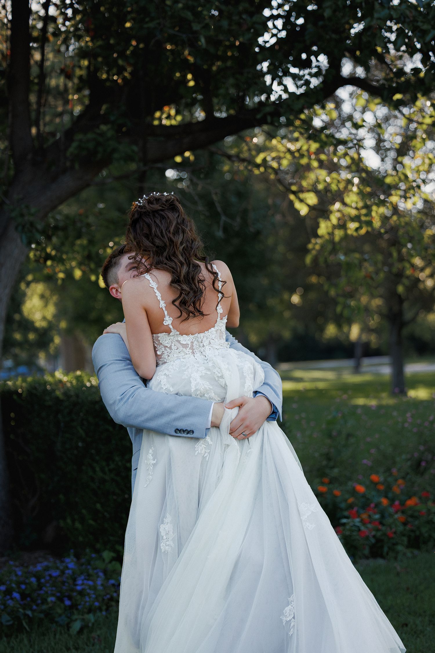 a bride and groom kissing in a garden on their wedding day photographed by a Kansas wedding photographer, Temri Photography