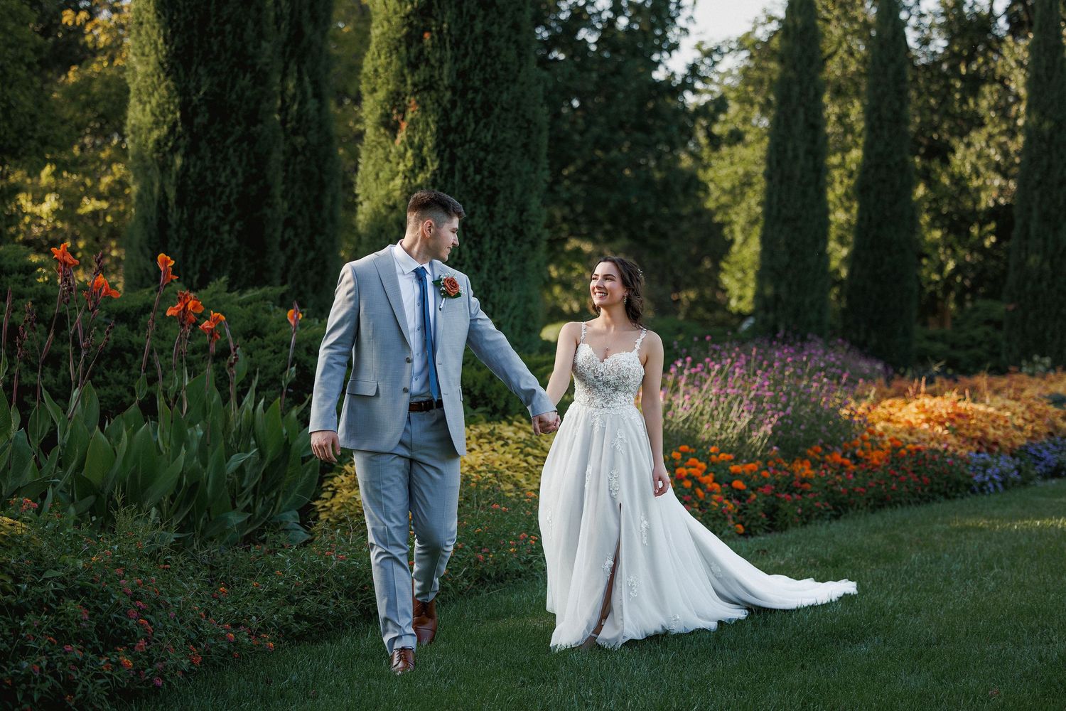 Romantic garden wedding scene with cypress trees and natural outdoor setting.
