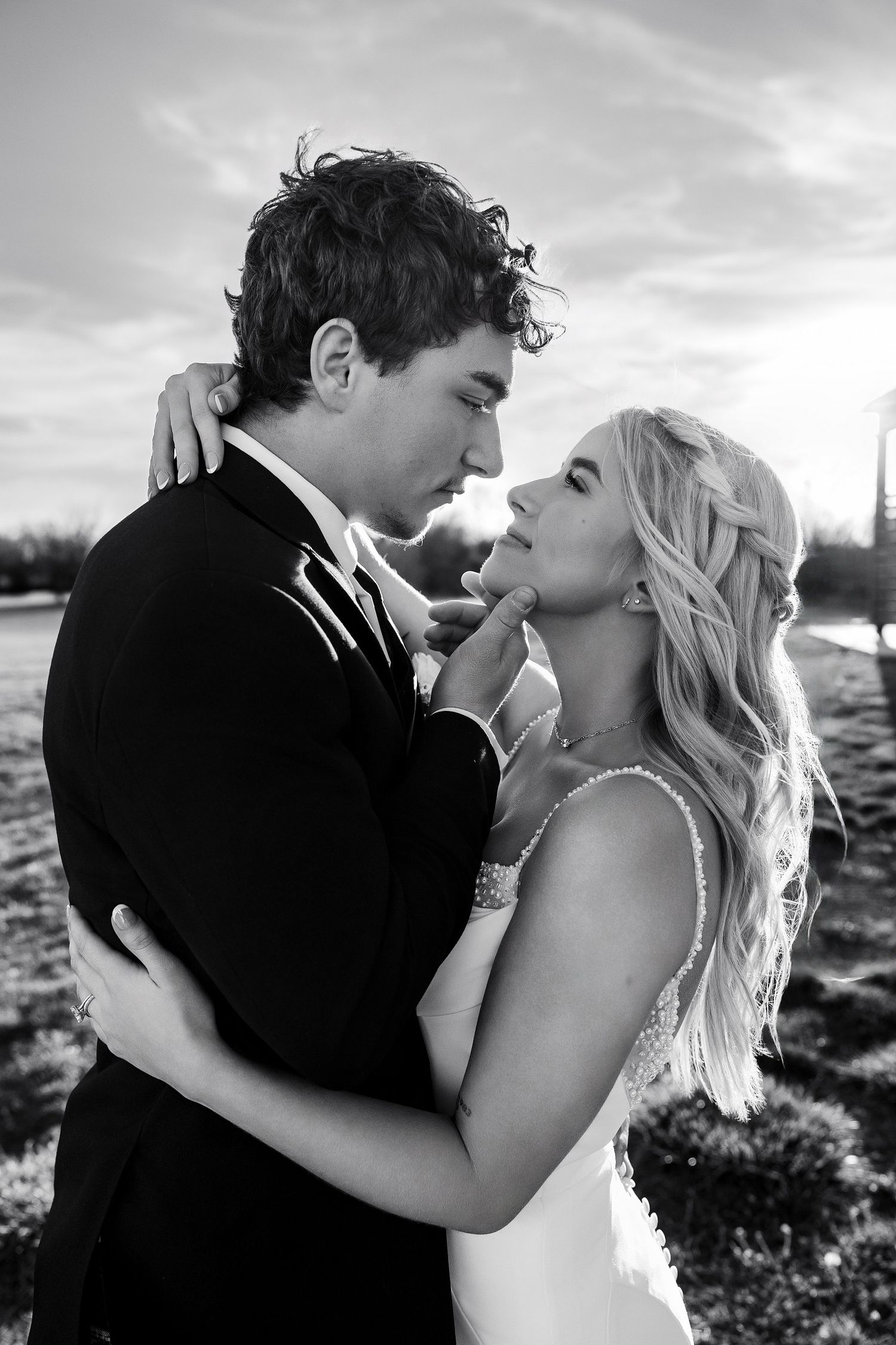 Black and white photo of a wichita bride and groom embracing outdoors, gazing at each other romantically by temri photography kansas wedding